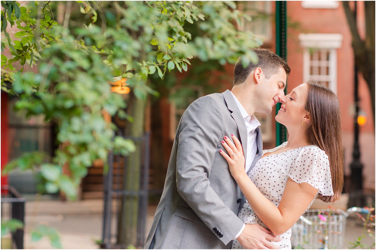 bride and groom to be almost kiss on city sidewalk in West Village