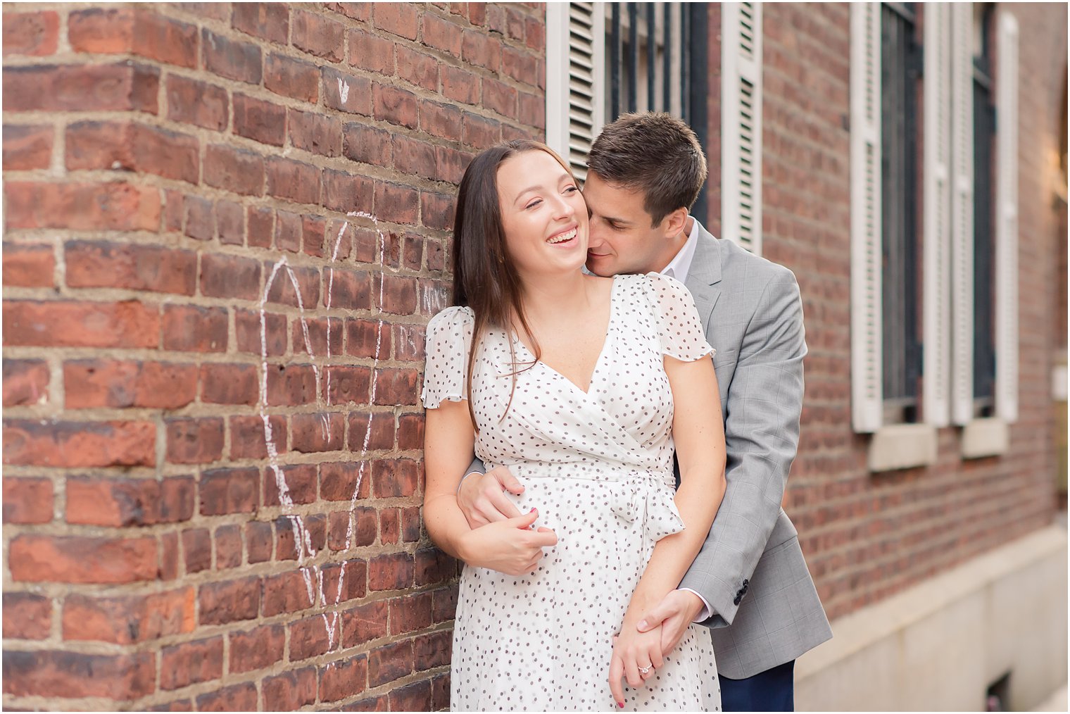 groom kisses bride's neck during West Village Engagement Photos