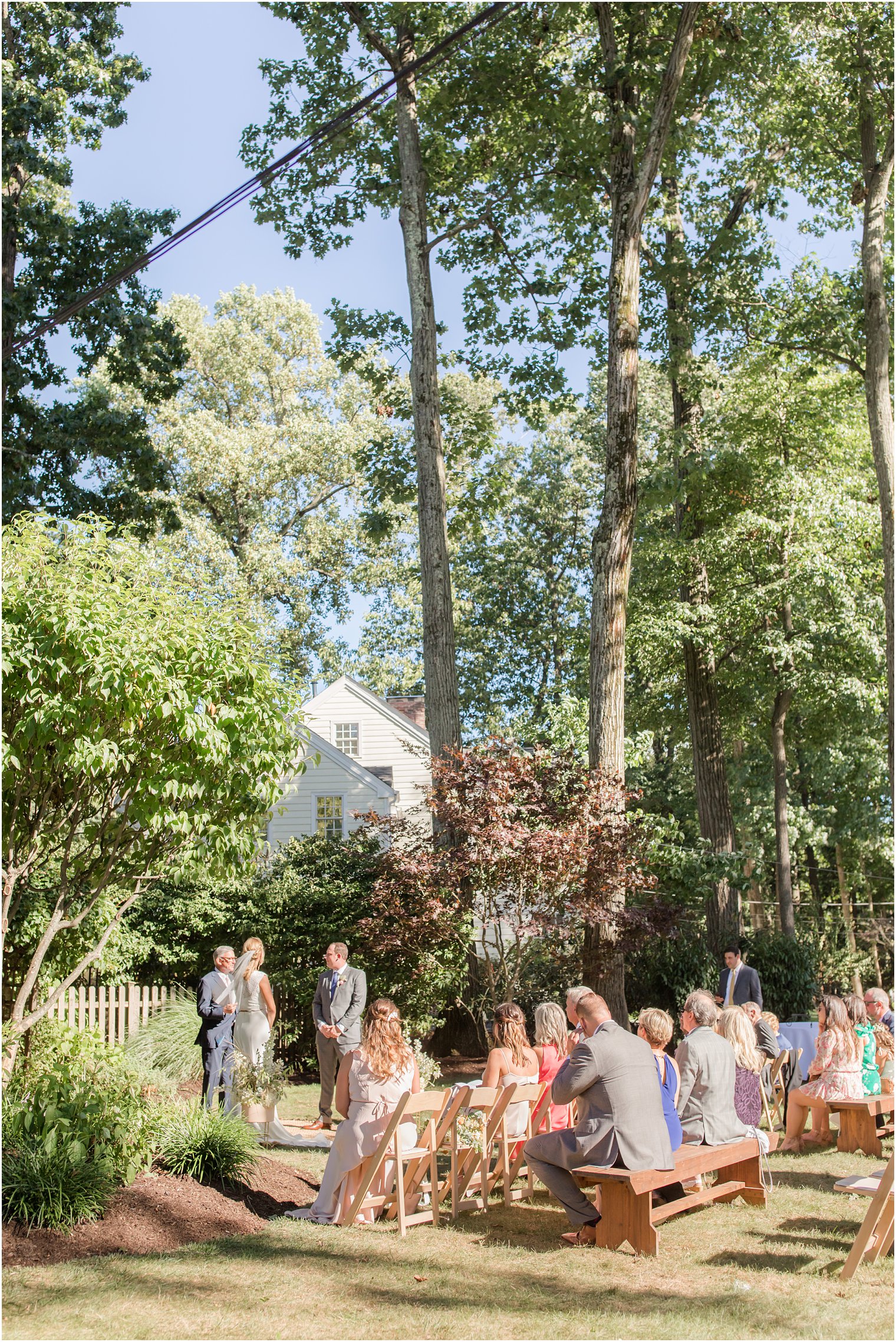 bride and groom exchange vows in outdoor backyard wedding ceremony
