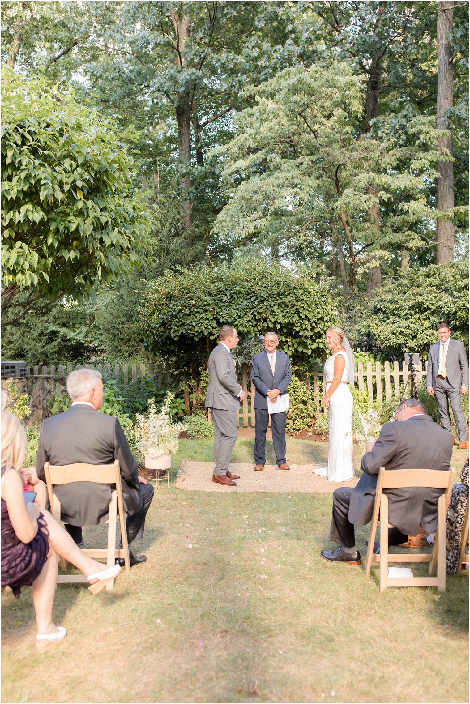 bride and groom exchange wedding vows in backyard