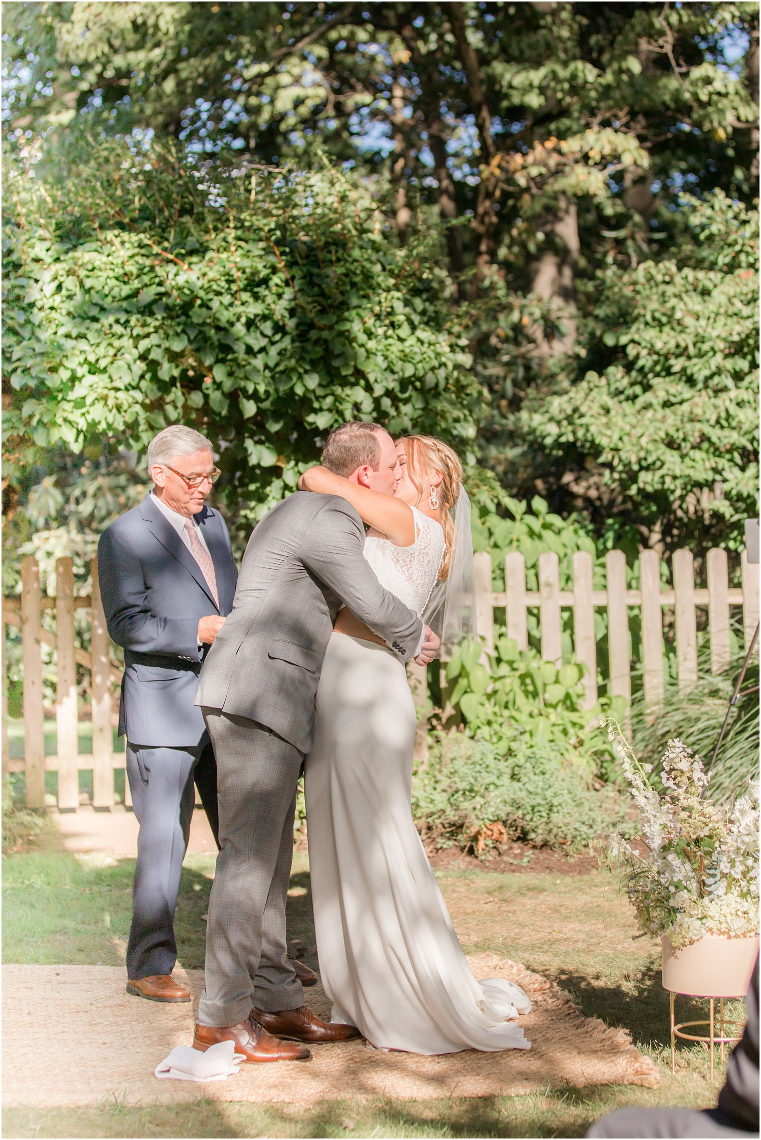 bride and groom kiss during Westfield NJ backyard wedding ceremony