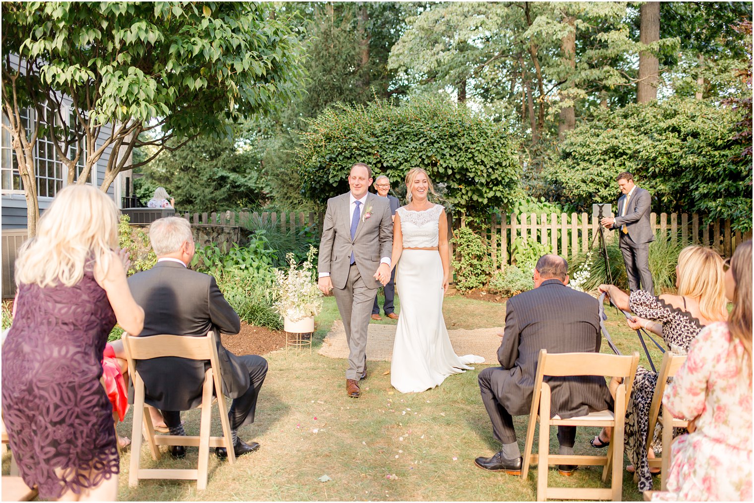 bride and groom walk up aisle after Westfield NJ backyard wedding