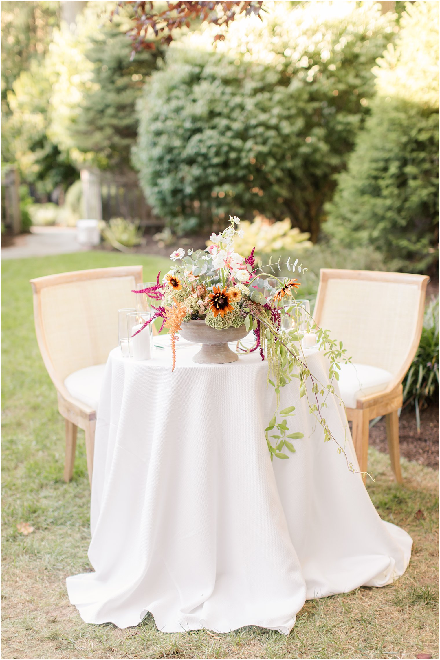 sweetheart table with orange and yellow wildflower centerpiece 
