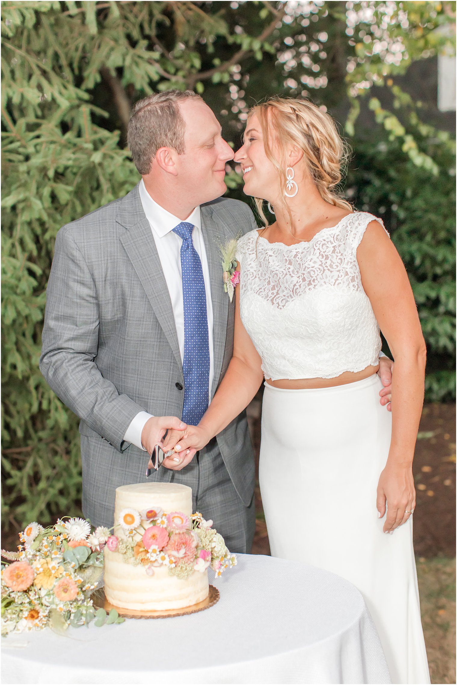 couple cuts wedding cake during Westfield NJ backyard wedding