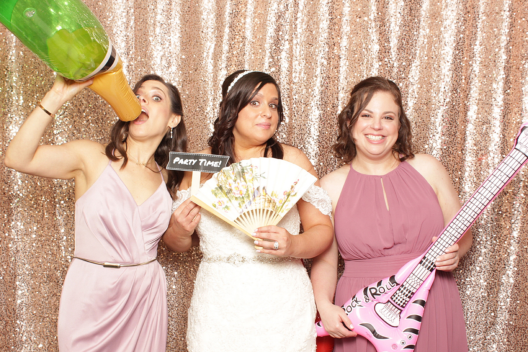 bride poses with two bridesmaids in Clarks Landing Yacht Club photo booth