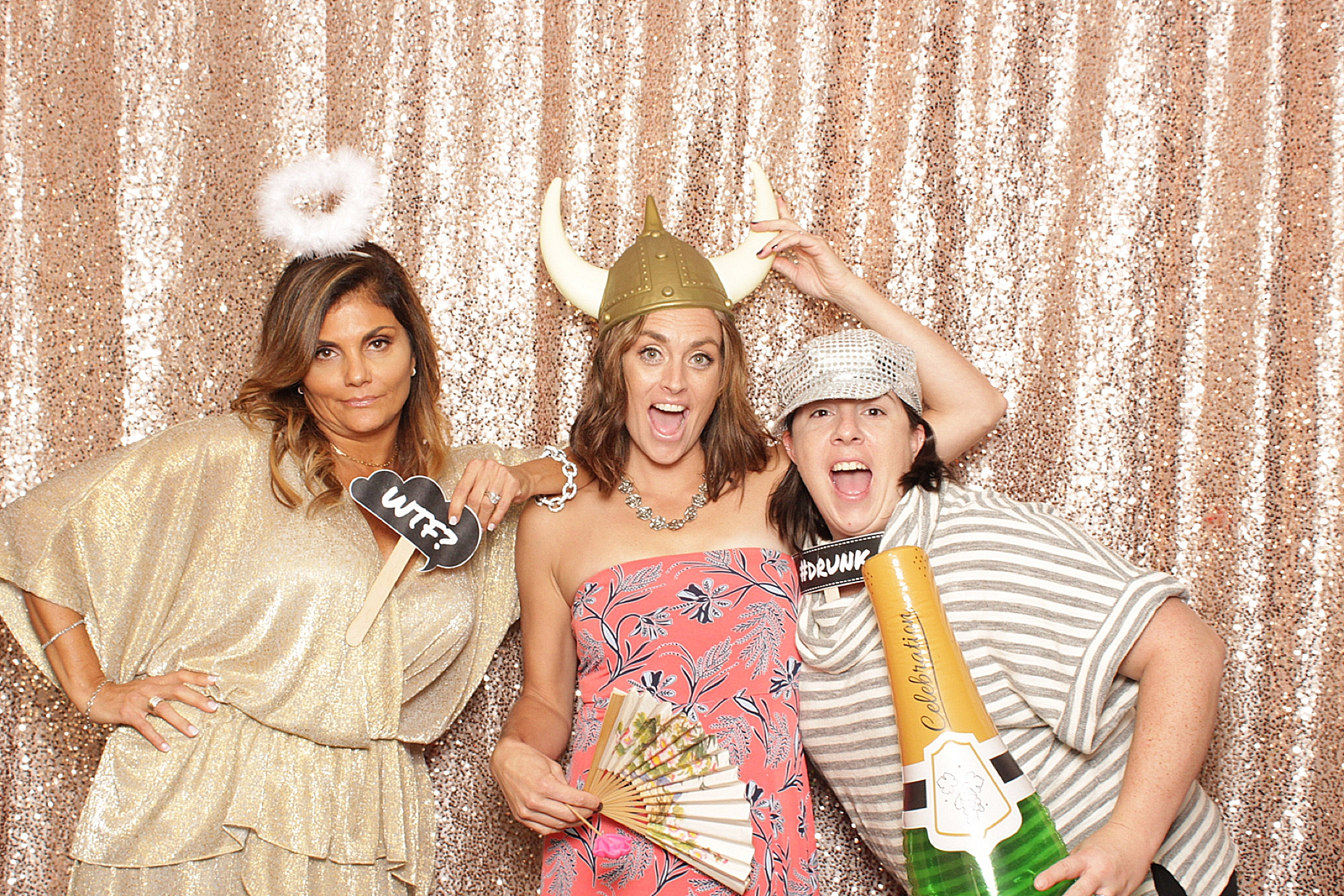 group of women pose in photo booth