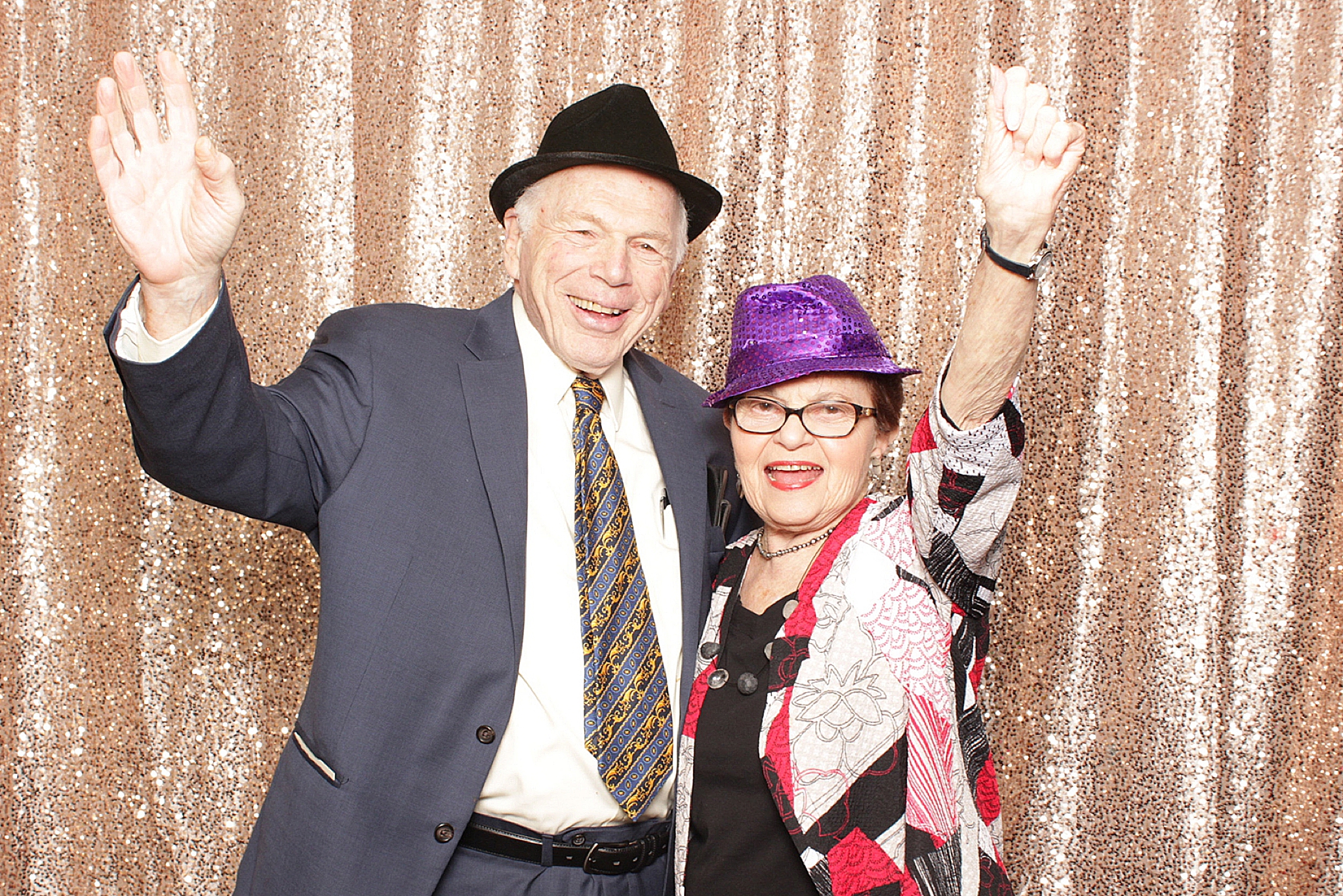 couple cheers during NJ wedding reception photo booth