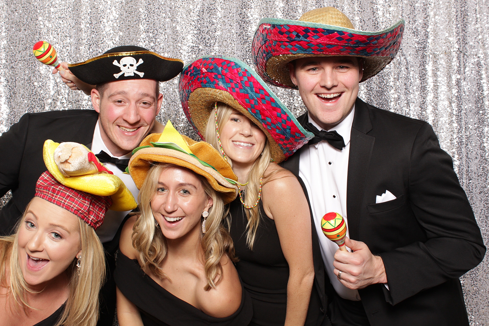 wedding guests in sombreros pose in photo booth