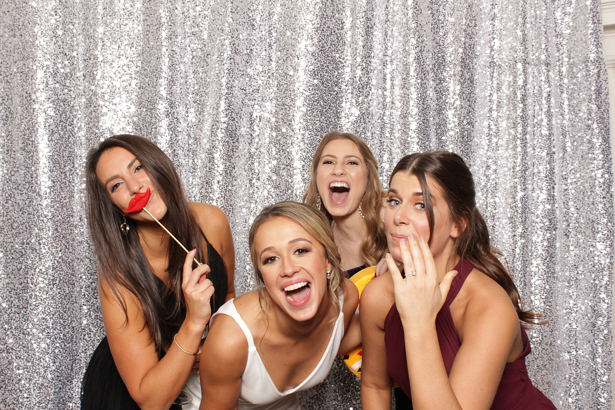 women laugh during fun in photo booth