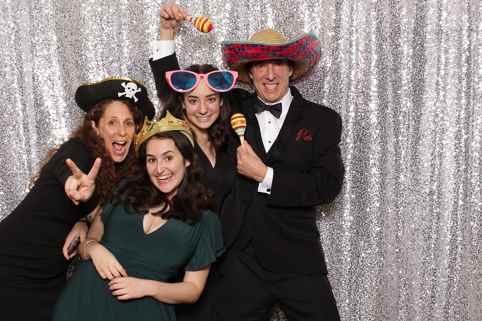 wedding guests play with props during photo booth