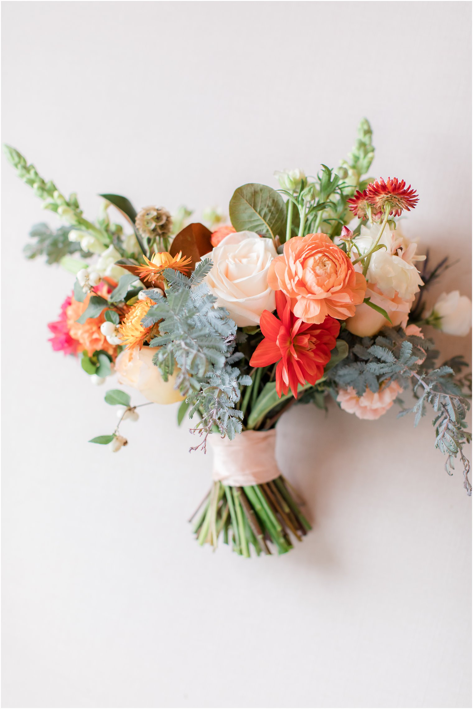 coral and red bouquet by Leigh Florist