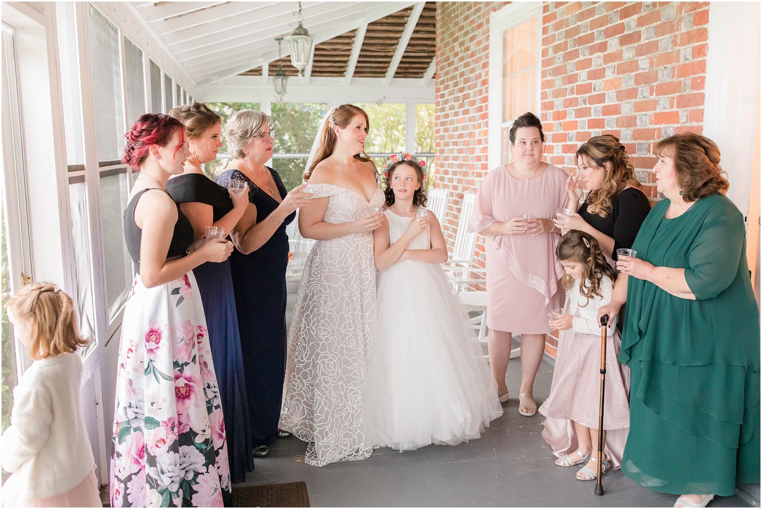 bride talks with bridesmaids and family before NJ wedding