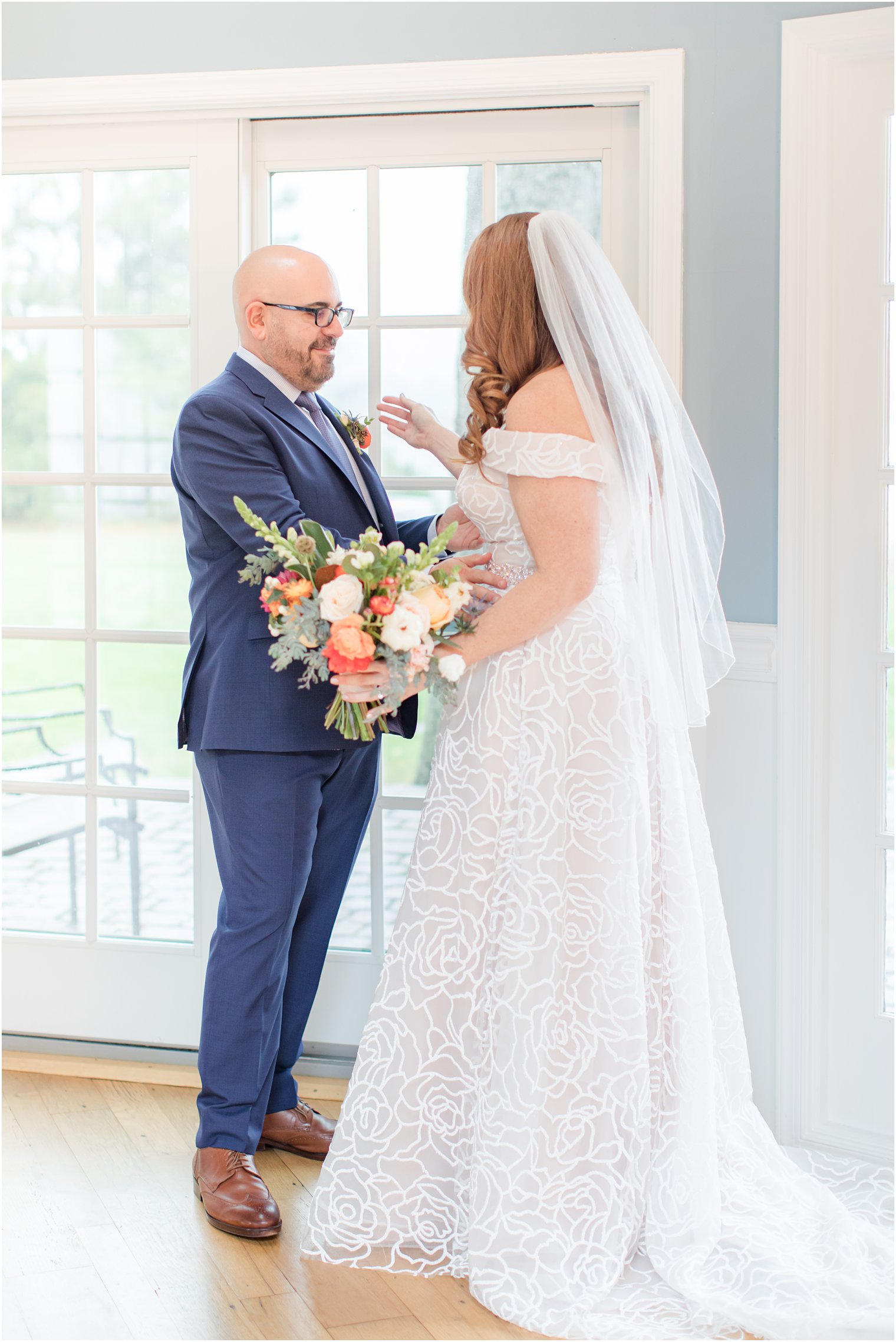 groom hugs bride during first look at Eagle Manor