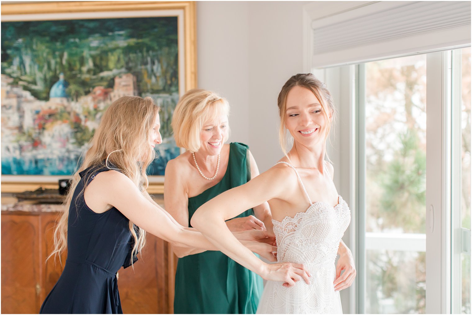 bridesmaid helps bride with wedding dress before Long Beach Island Intimate Wedding