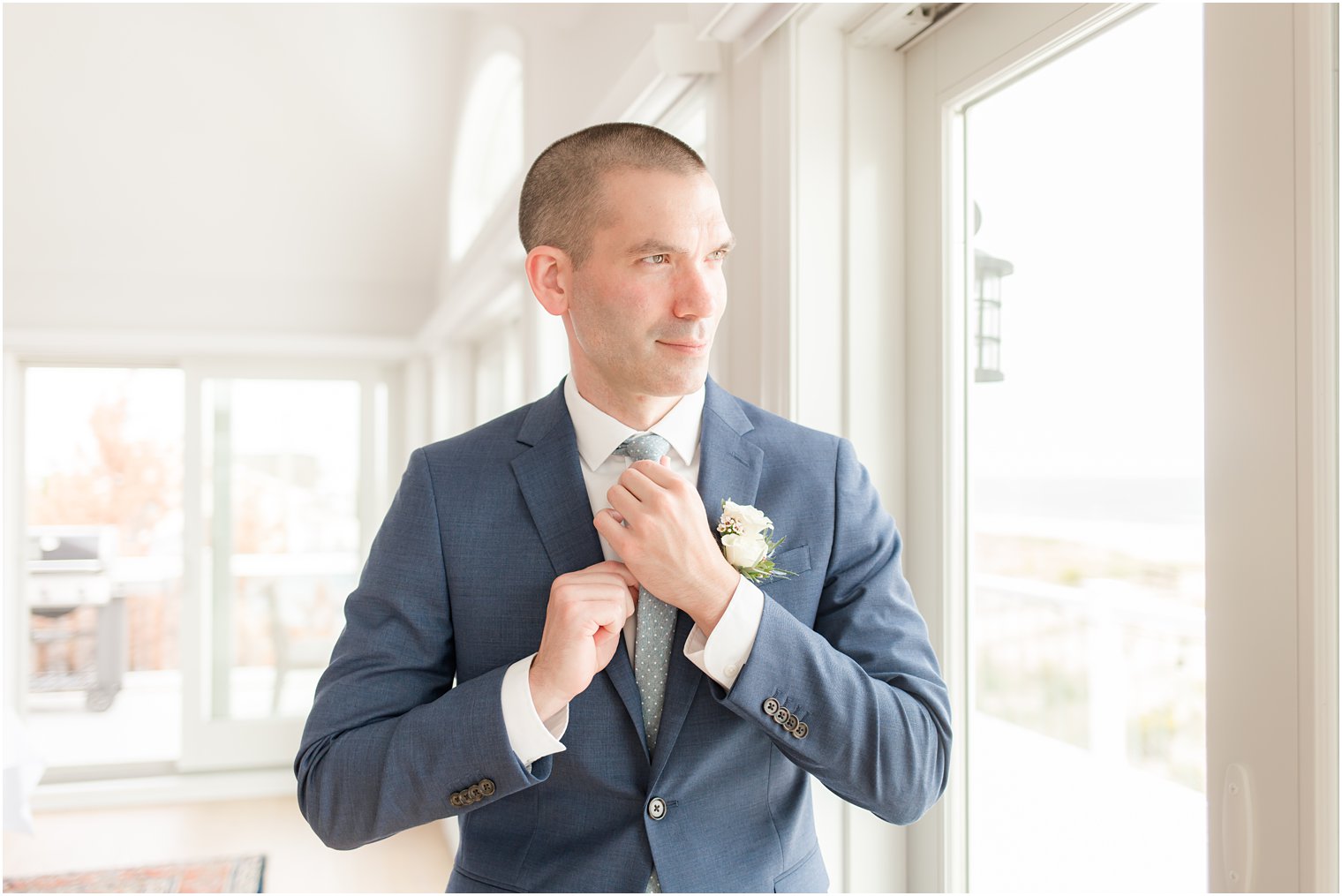 groom adjusts tie before Long Beach Island wedding