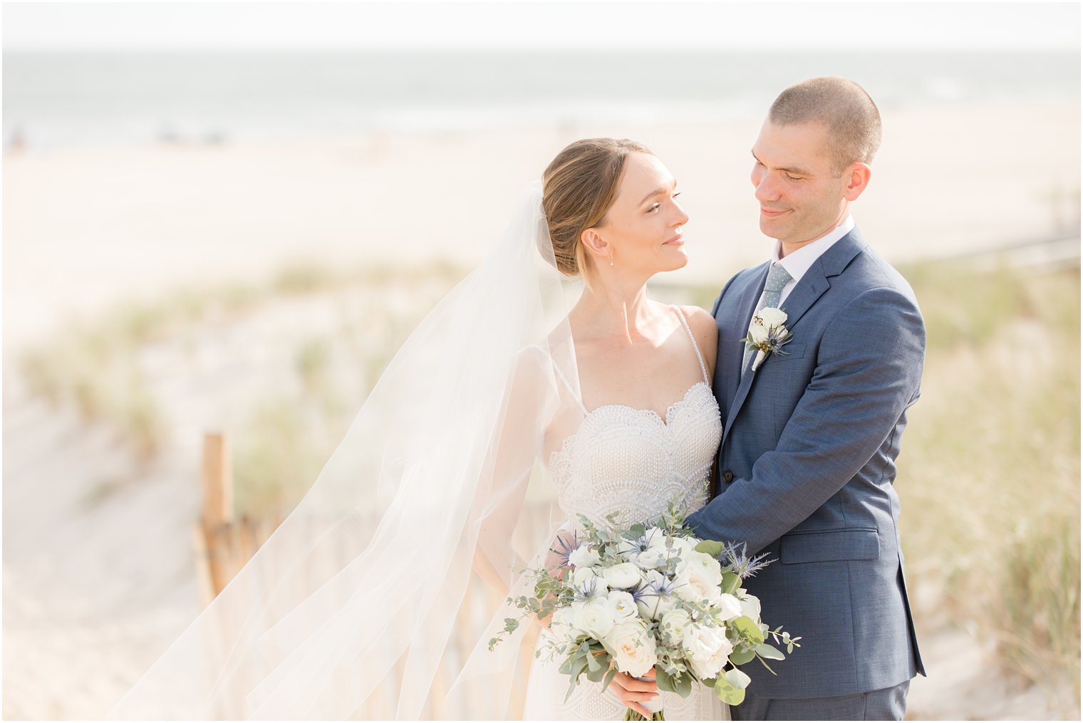 bride and groom pose on Long Beach Island in New Jersey