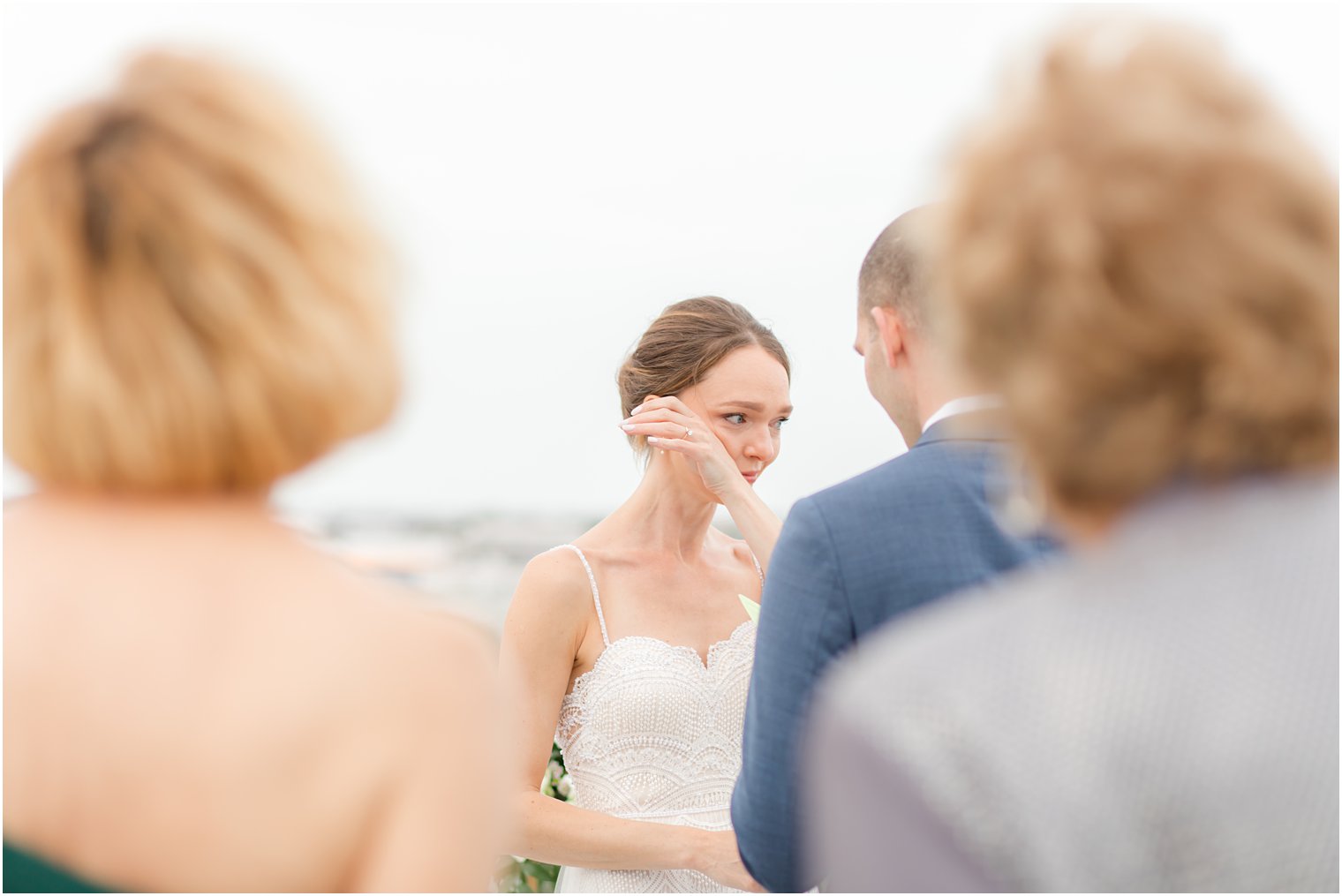 bride cries during intimate beach wedding ceremony