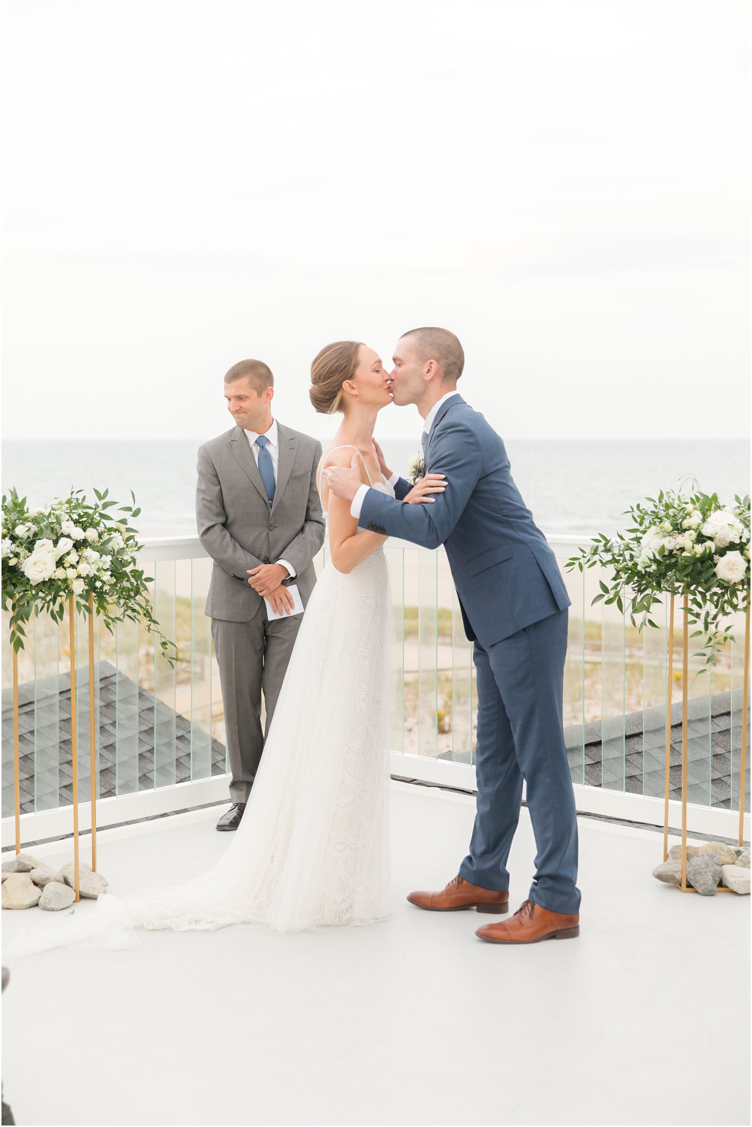 groom kisses bride after wedding ceremony