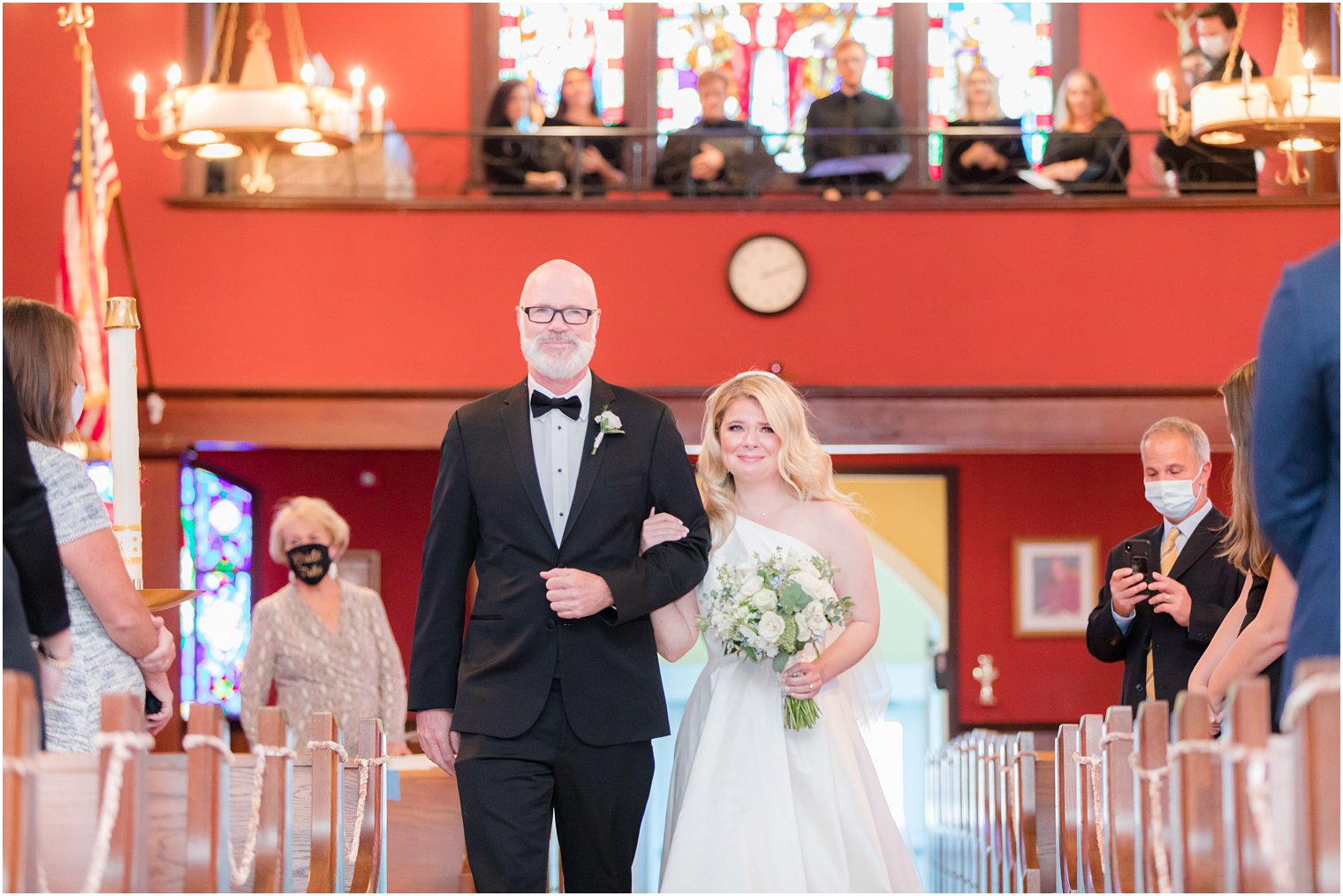 bride cries walking down aisle during traditional church wedding in New Jersey