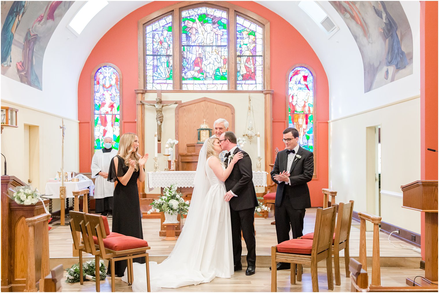 newlyweds kiss after traditional church wedding in New Jersey