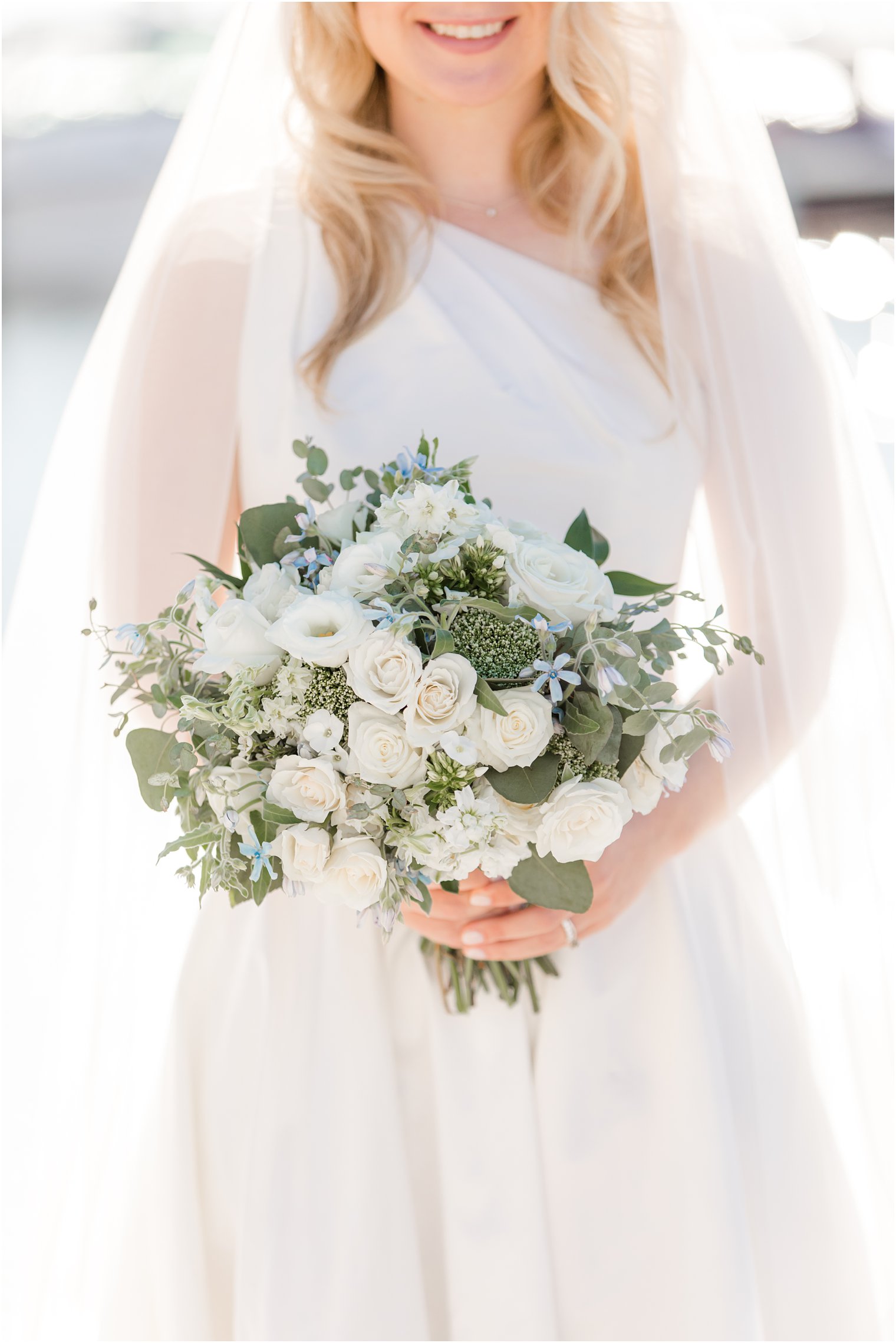 fall wedding bouquet with ivory flowers and greenery 