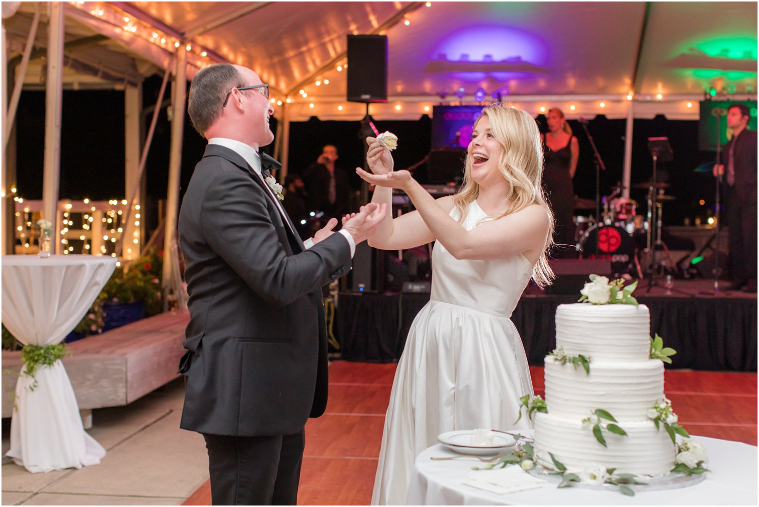bride and groom cut wedding cake during Mantoloking Yacht Club Wedding reception