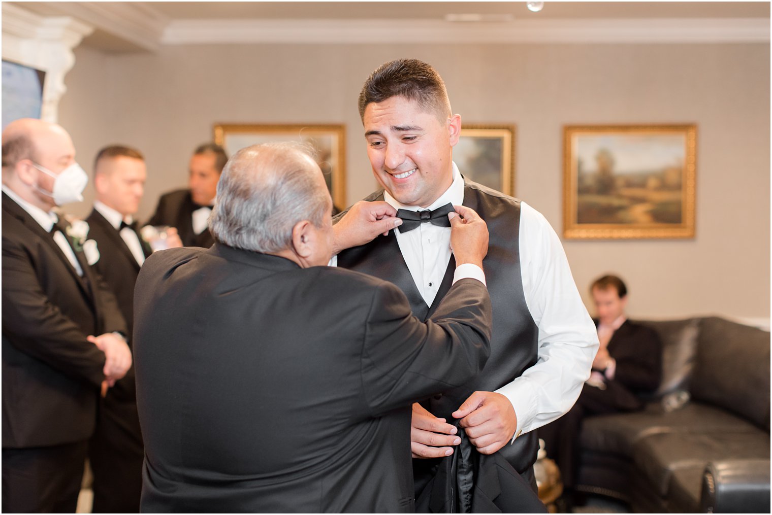 dad serves as son's best man and adjusts tie on wedding day