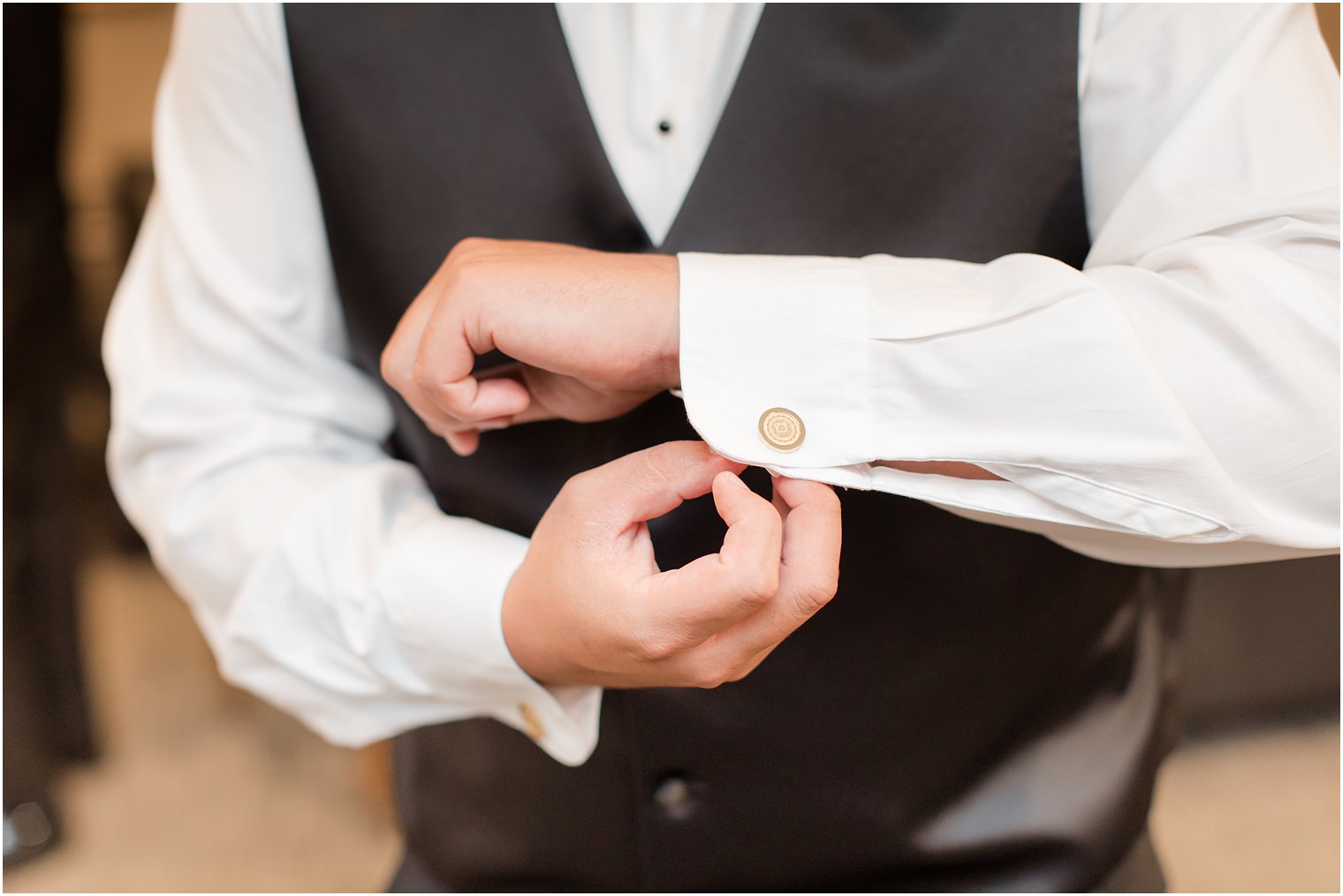 groom adjusts cufflinks before Nanina's in the Park wedding