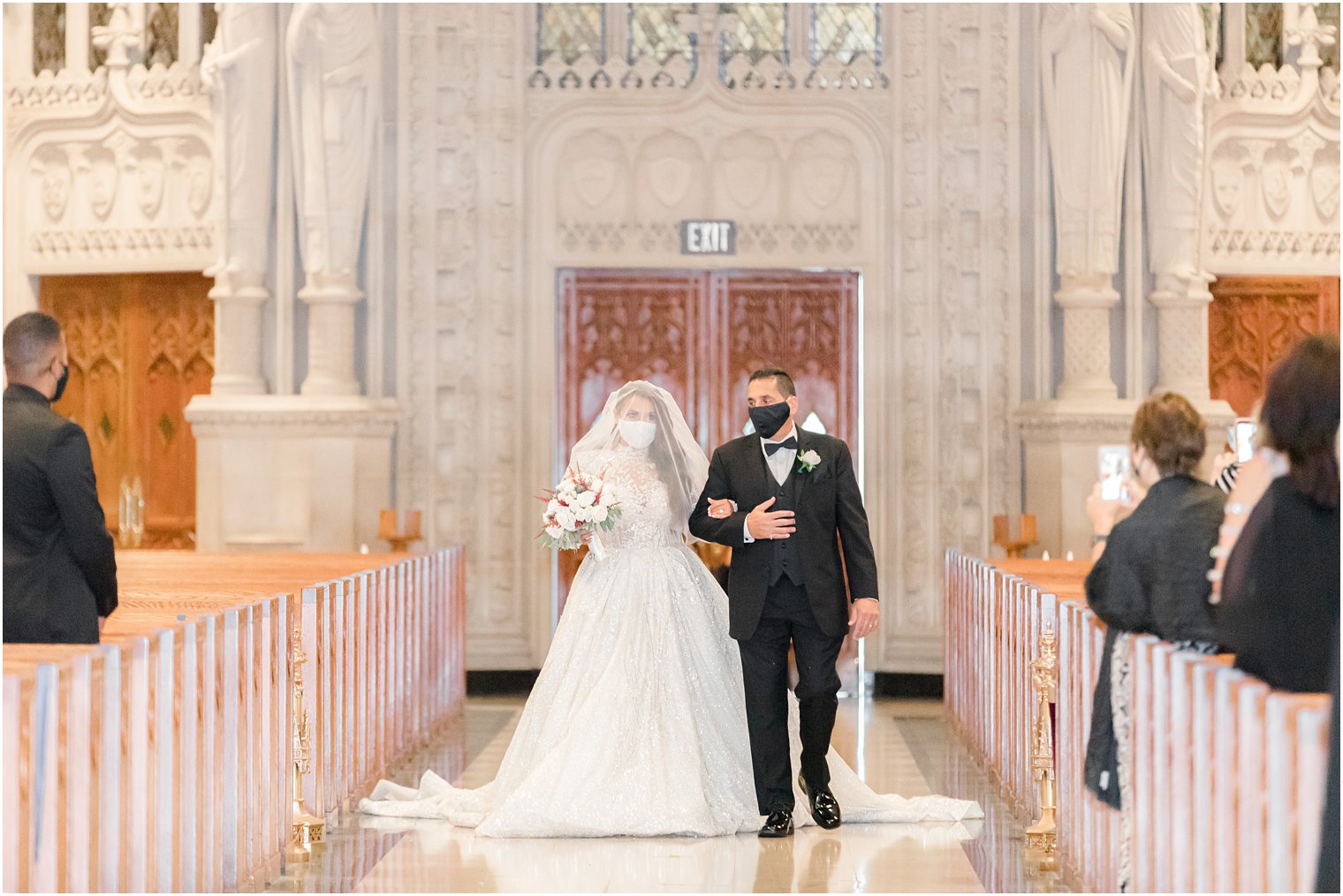 bride and dad in masks walk down aisle at Cathedral Basilica of the Sacred Heart
