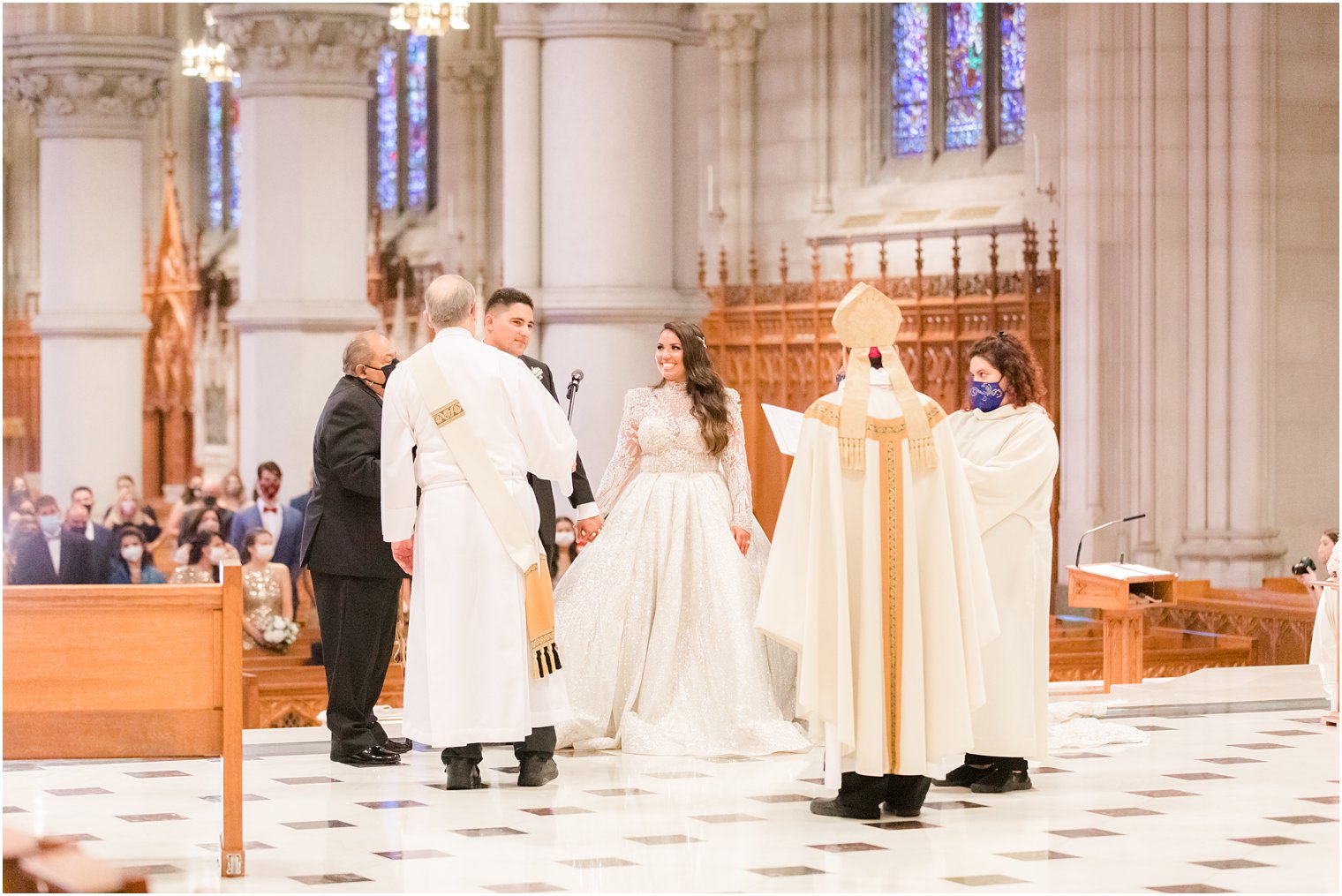 father gives blessing during traditional Catholic wedding at Cathedral Basilica of the Sacred Heart in Newark NJ