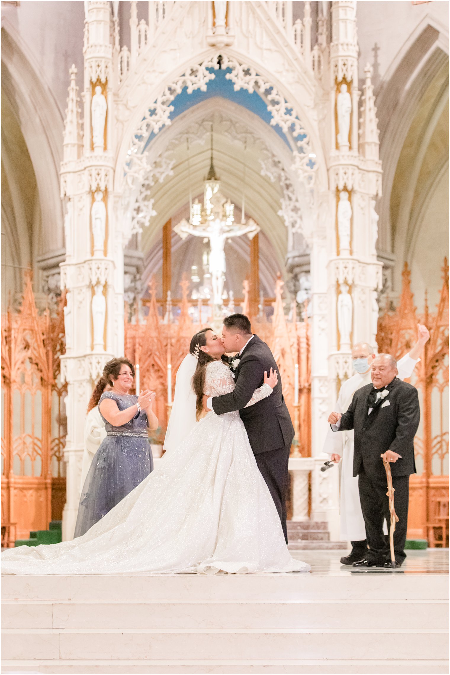 newlyweds kiss during traditional Catholic wedding at Cathedral Basilica of the Sacred Heart in Newark NJ
