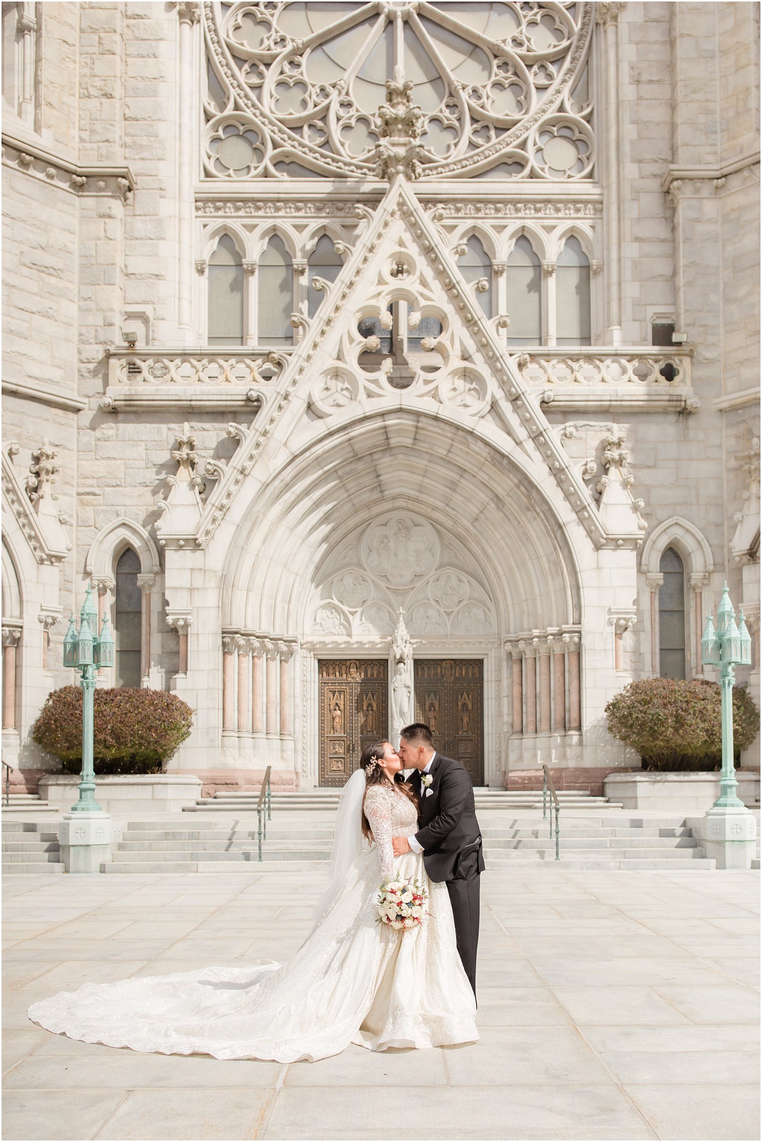 bride and groom kiss outside Cathedral Basilica of the Sacred Heart in Newark NJ