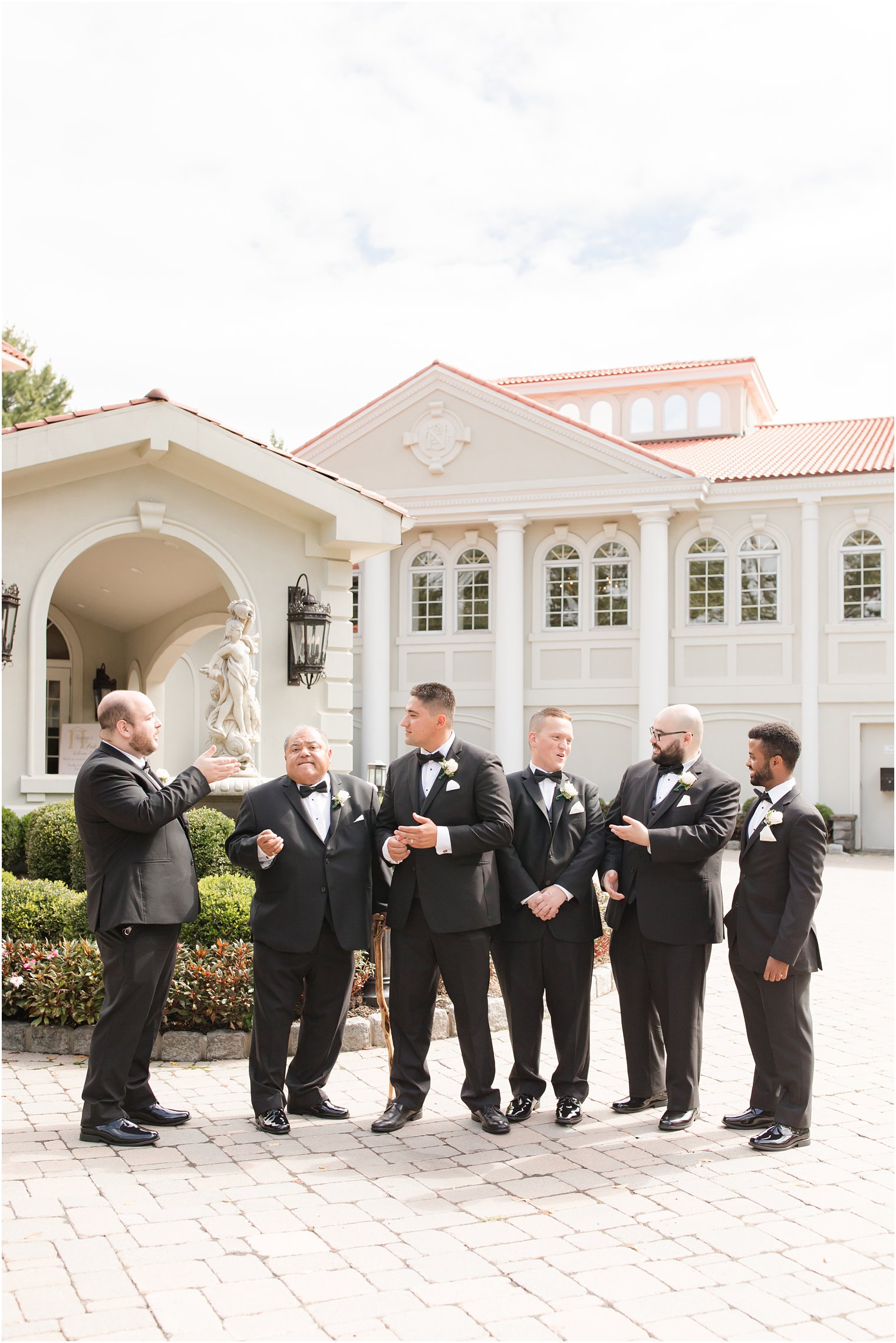 New Jersey groomsmen talk during wedding photos