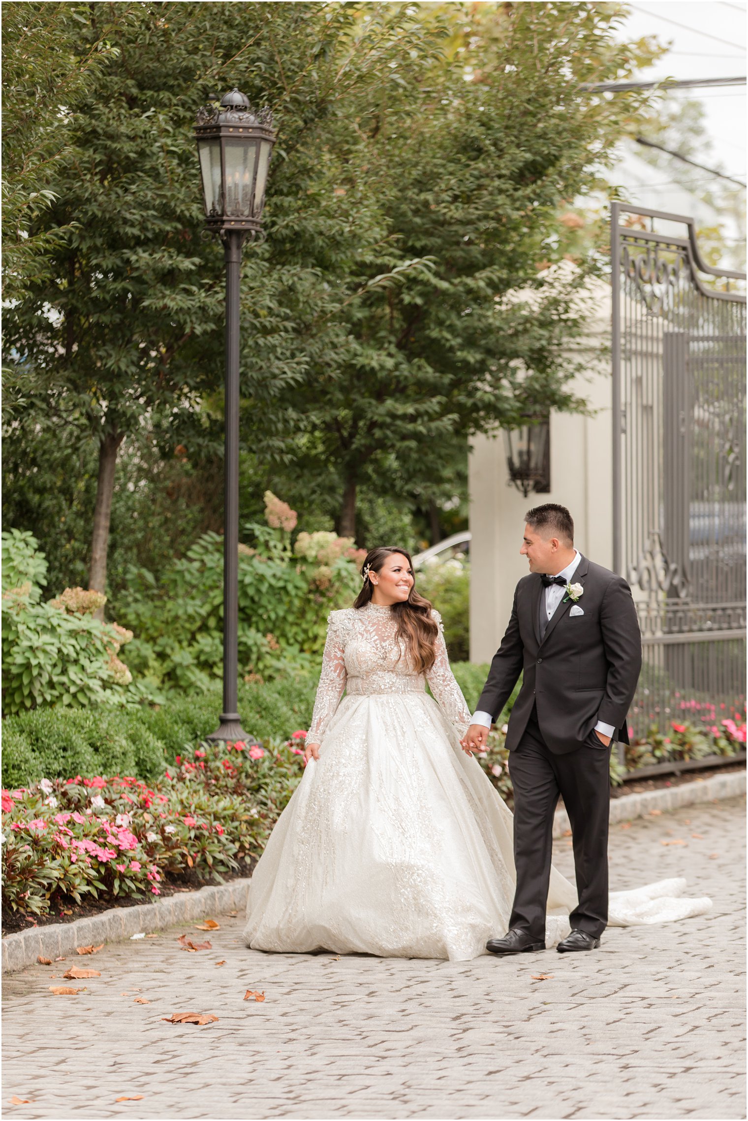 Belleville NJ wedding portraits of bride and groom walking by gate