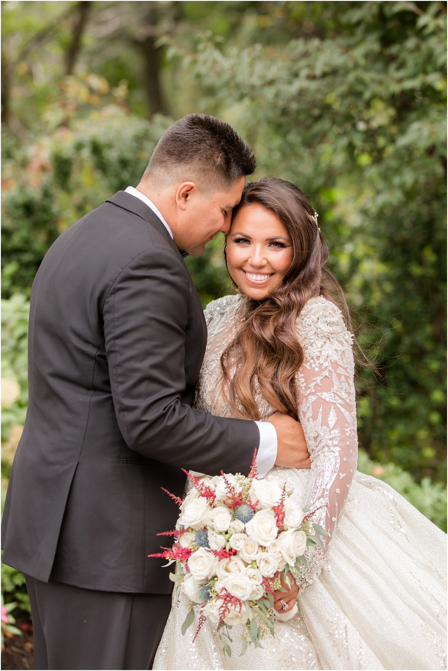 groom nuzzles bride's forehead during wedding photos in Belleville NJ