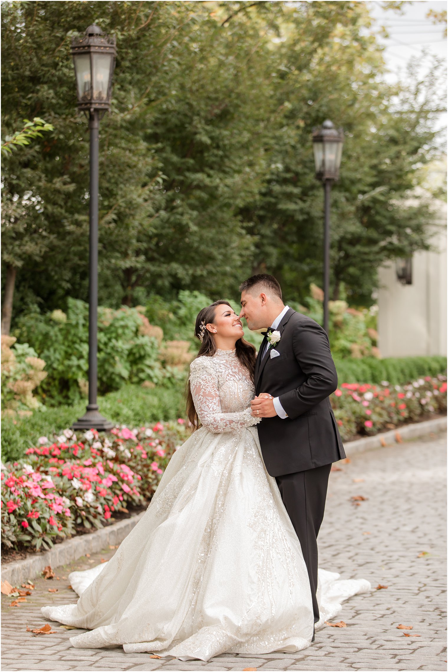 newlyweds touch noses outside in the gardens at Nanina's in the Park