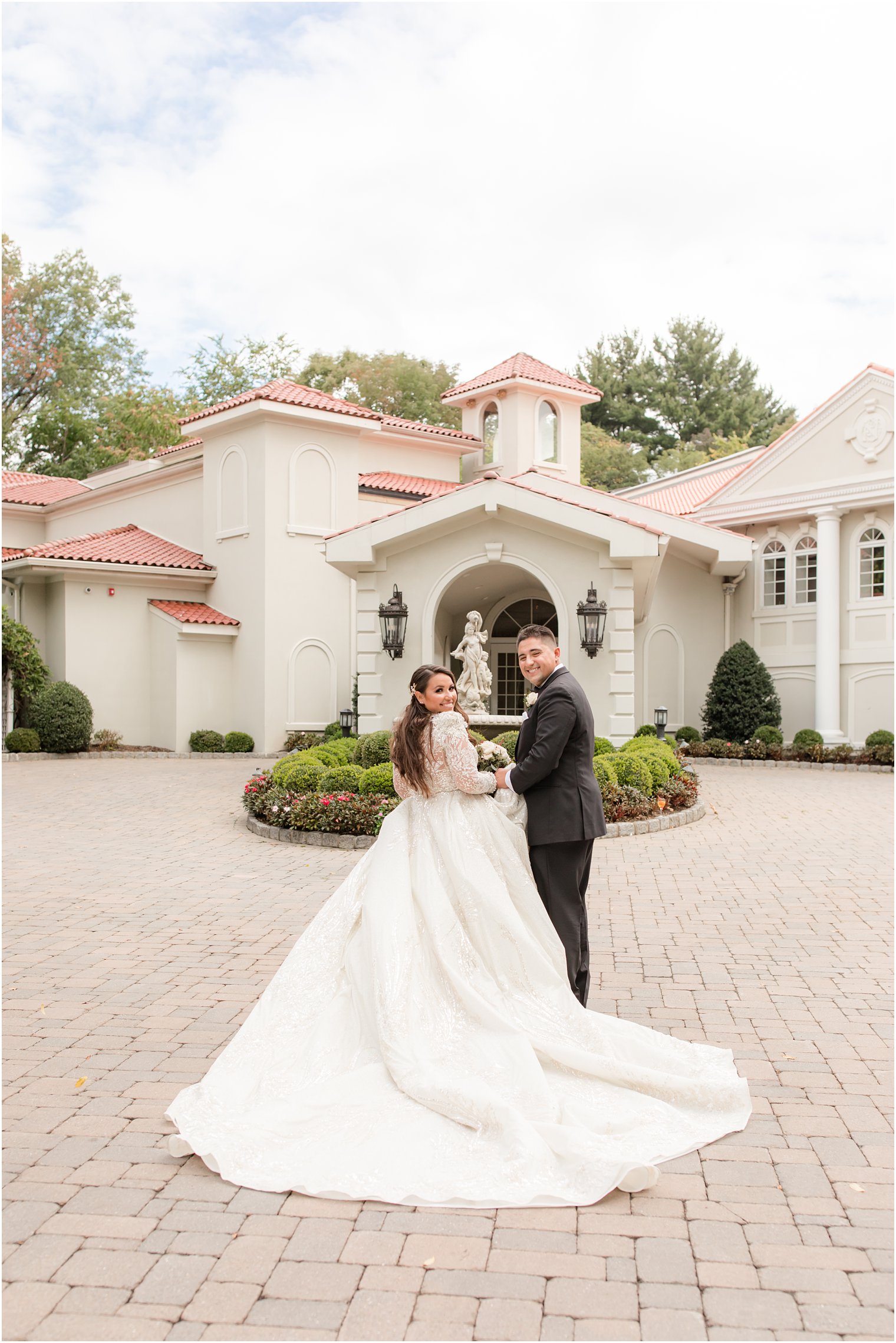 bride and groom look over shoulders during NJ wedding photos