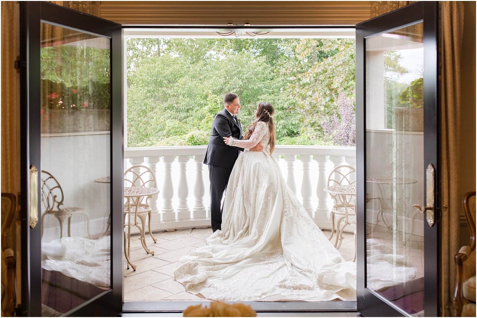 newlyweds pose on balcony at Nanina's in the Park