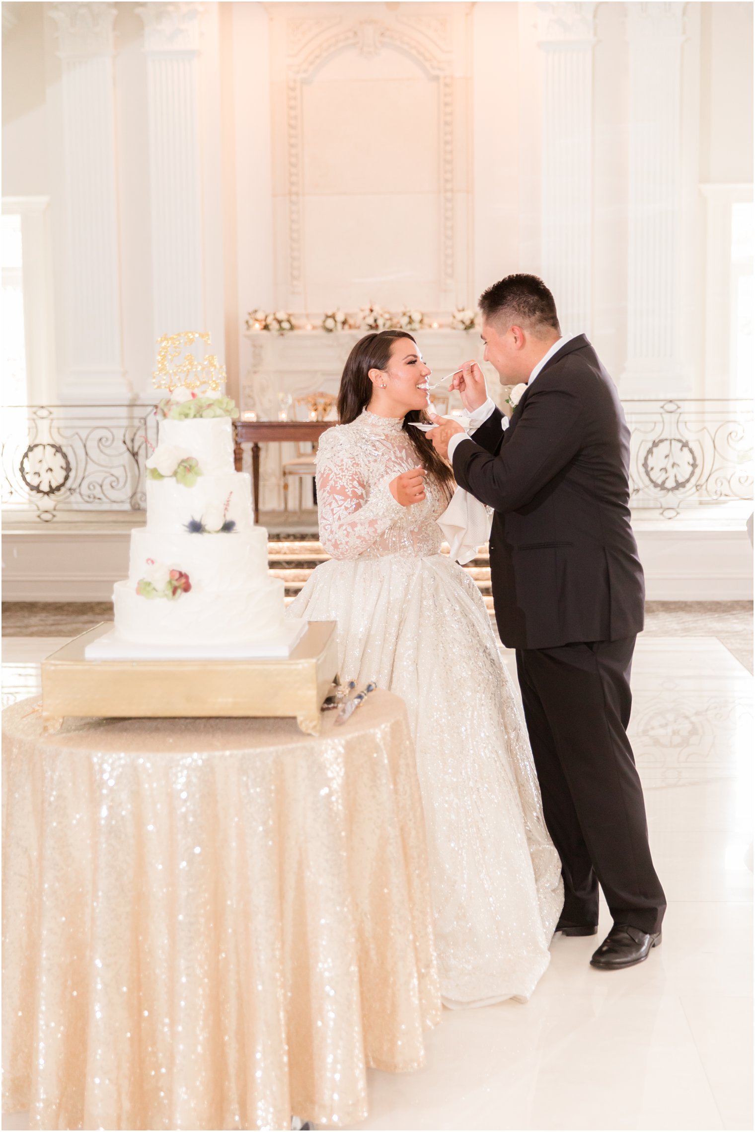 bride and groom cut wedding cake during Nanina's in the Park wedding reception