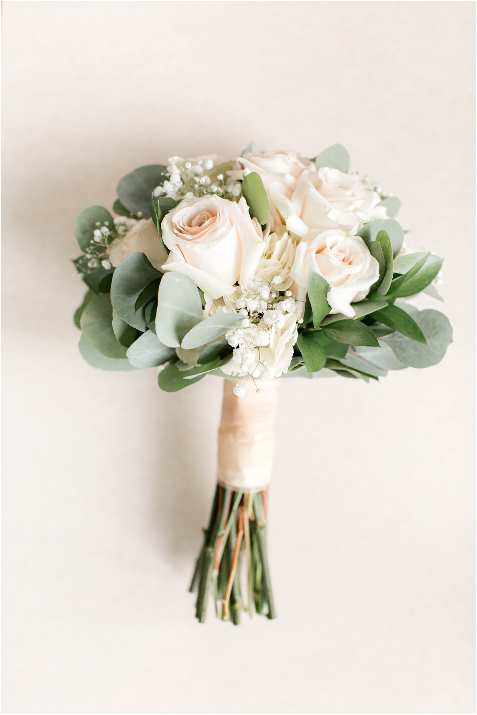 wedding bouquet with ivory roses by South Jersey Florist
