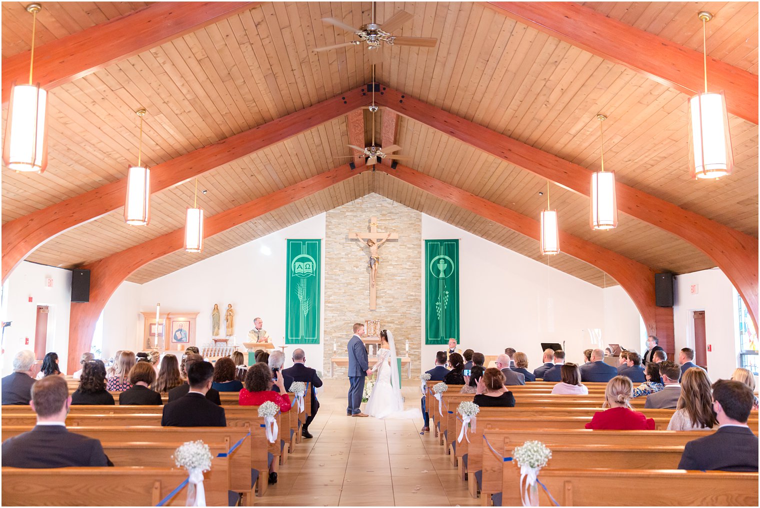 newlyweds pray together during traditional church wedding in New Jersey