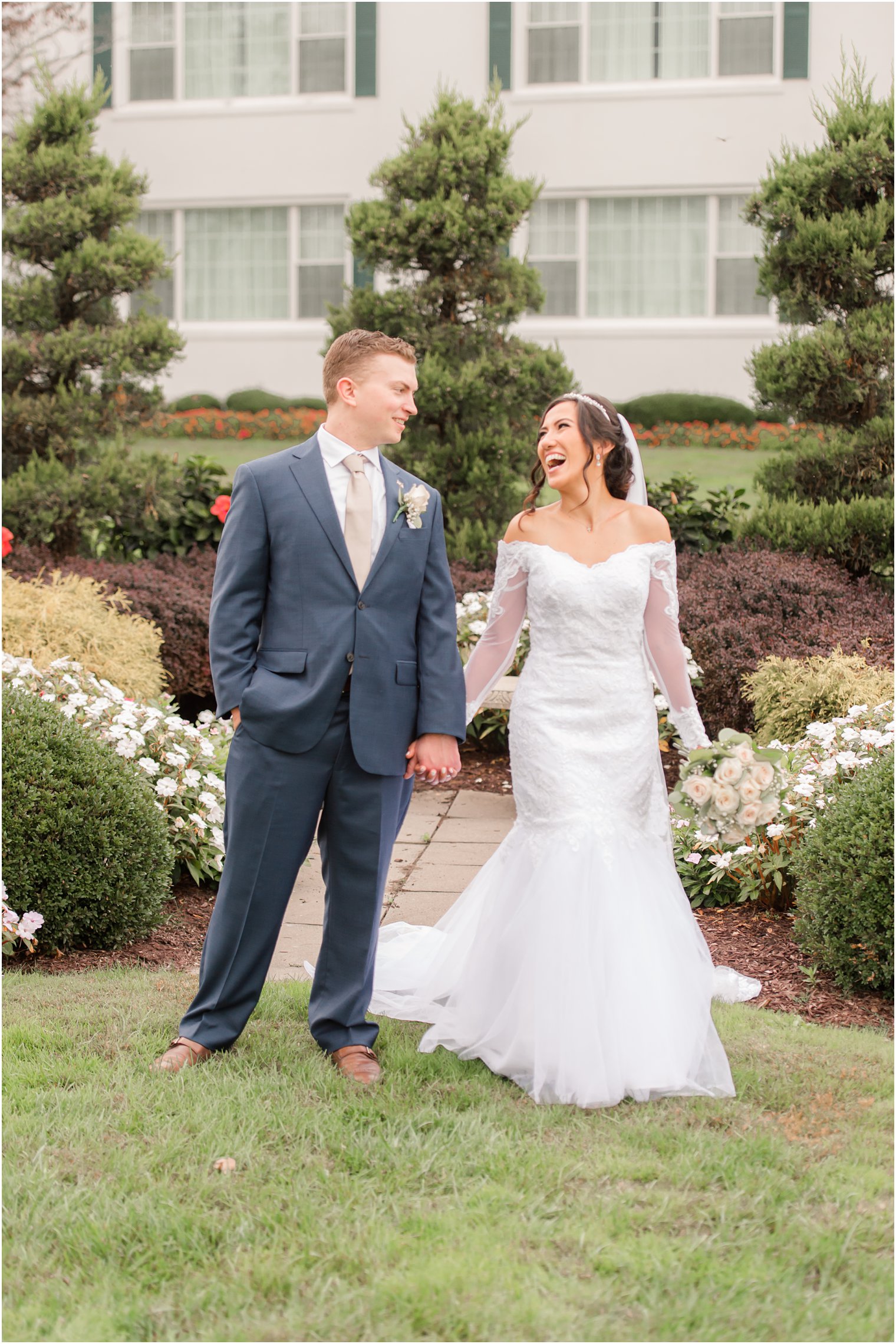 bride laughs during NJ wedding photos with groom at Seaview Hotel