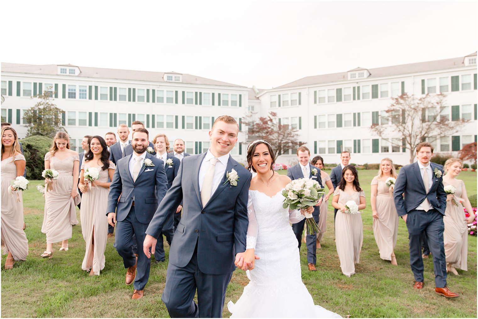 newlyweds walk with bridal party in New Jersey
