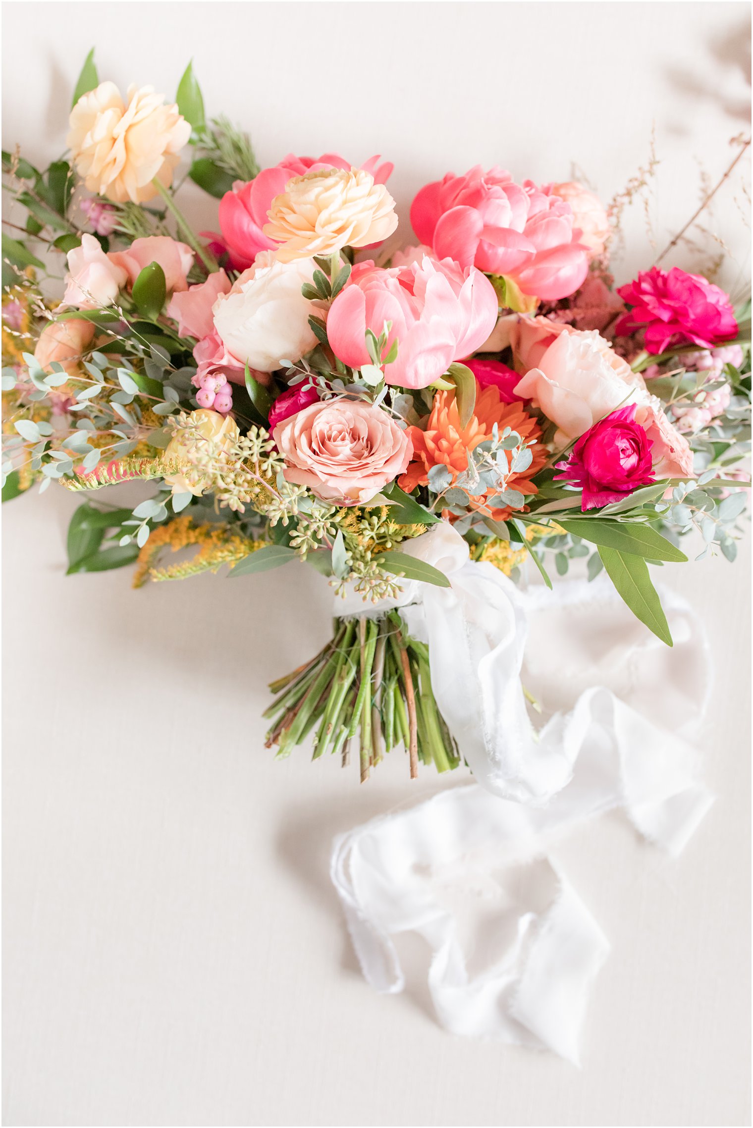 wedding bouquet with pink peonies and cascading ribbon