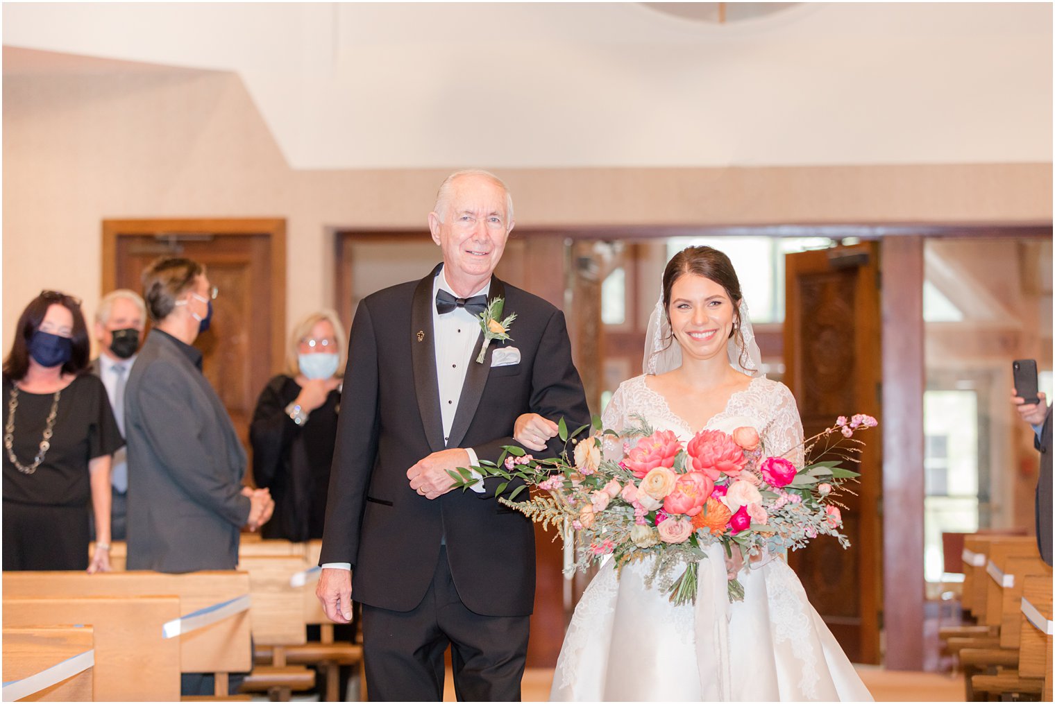 bride walks down aisle with dad during traditional wedding ceremony in New Jersey