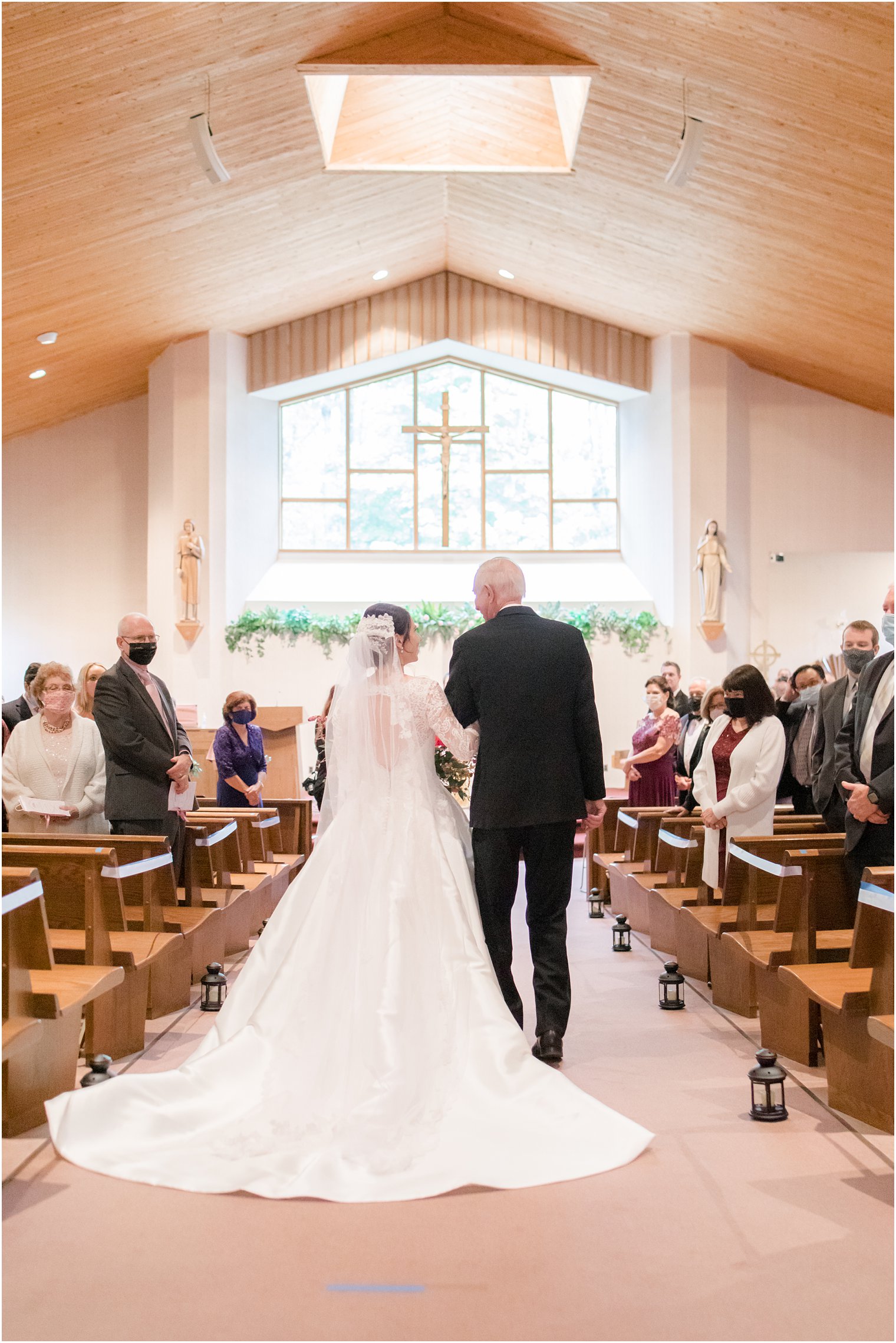 bride and father walk down aisle for traditional wedding ceremony in New Jersey