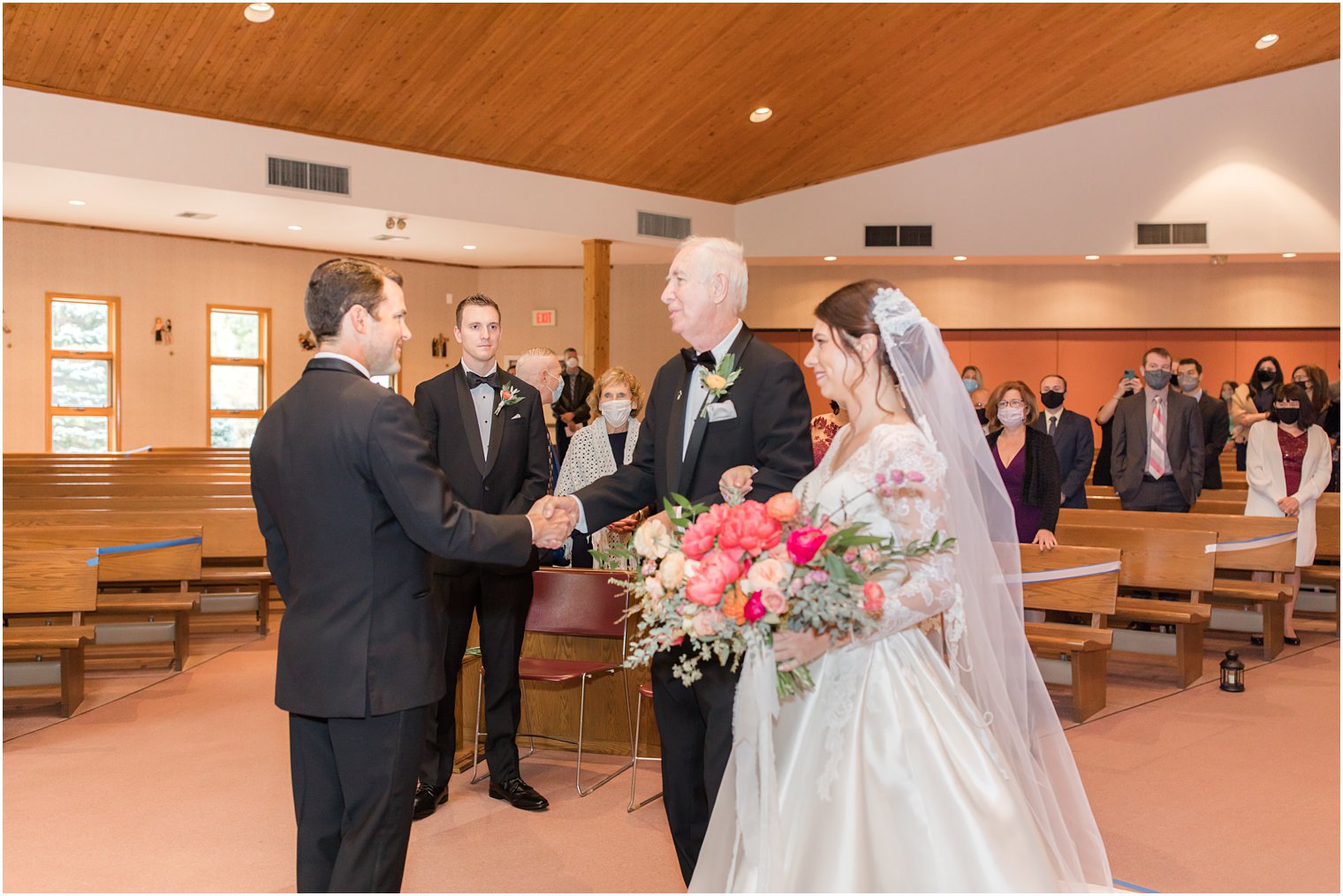 bride's father gives bride away during traditional wedding ceremony in New Jersey
