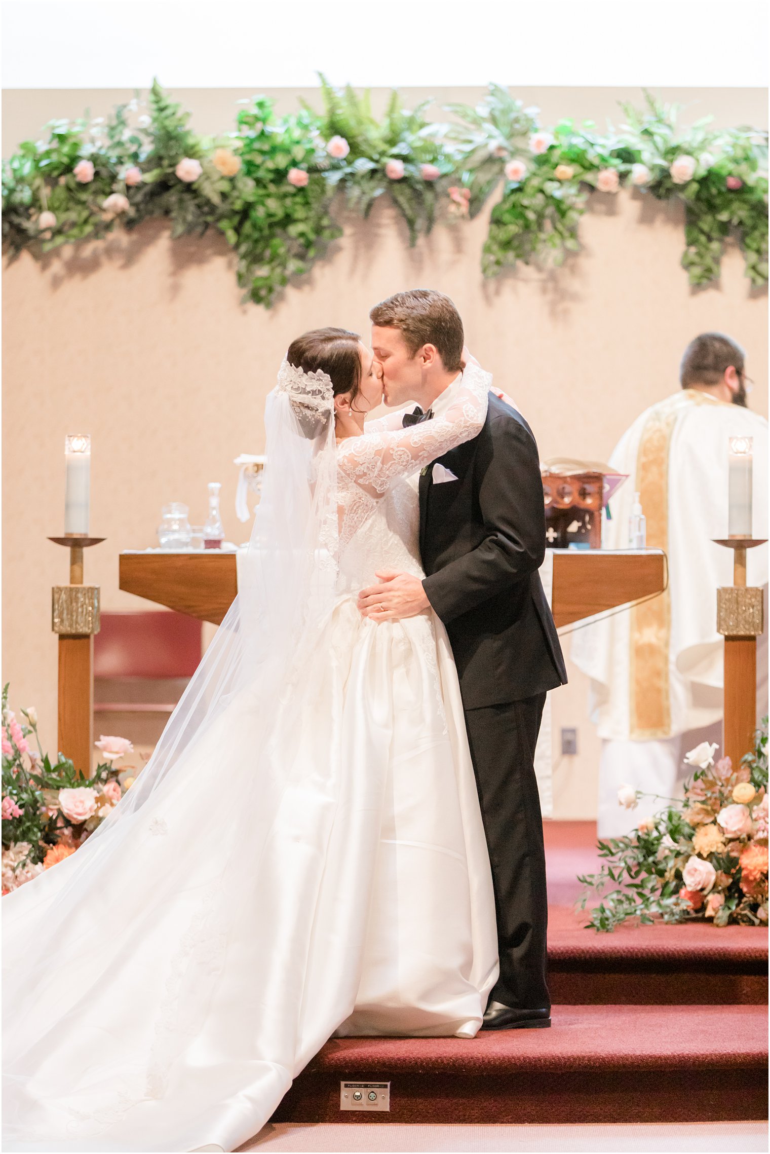 newlyweds kiss during traditional wedding ceremony in New Jersey