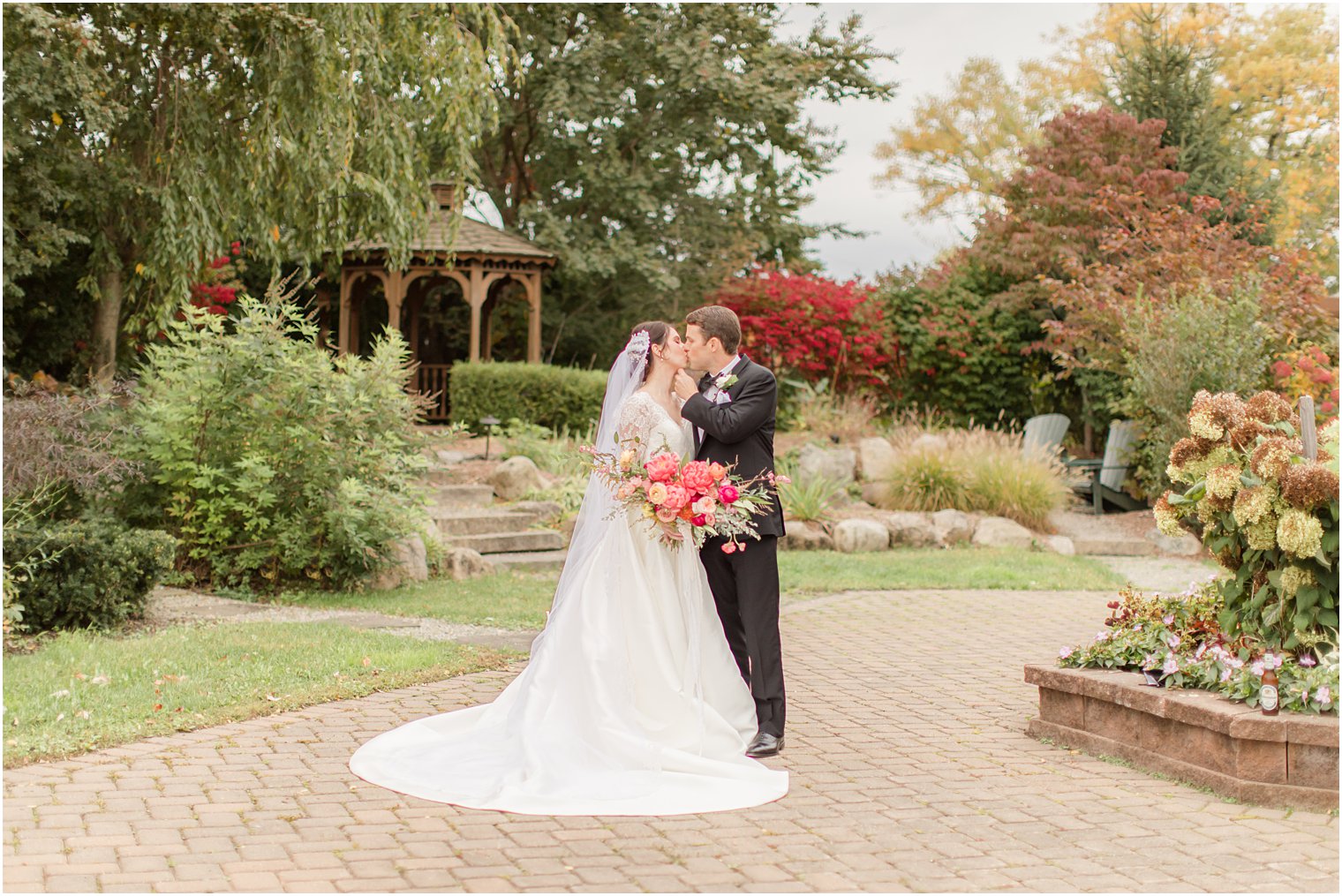 bride and groom kiss in Sussex County fairgrounds garden