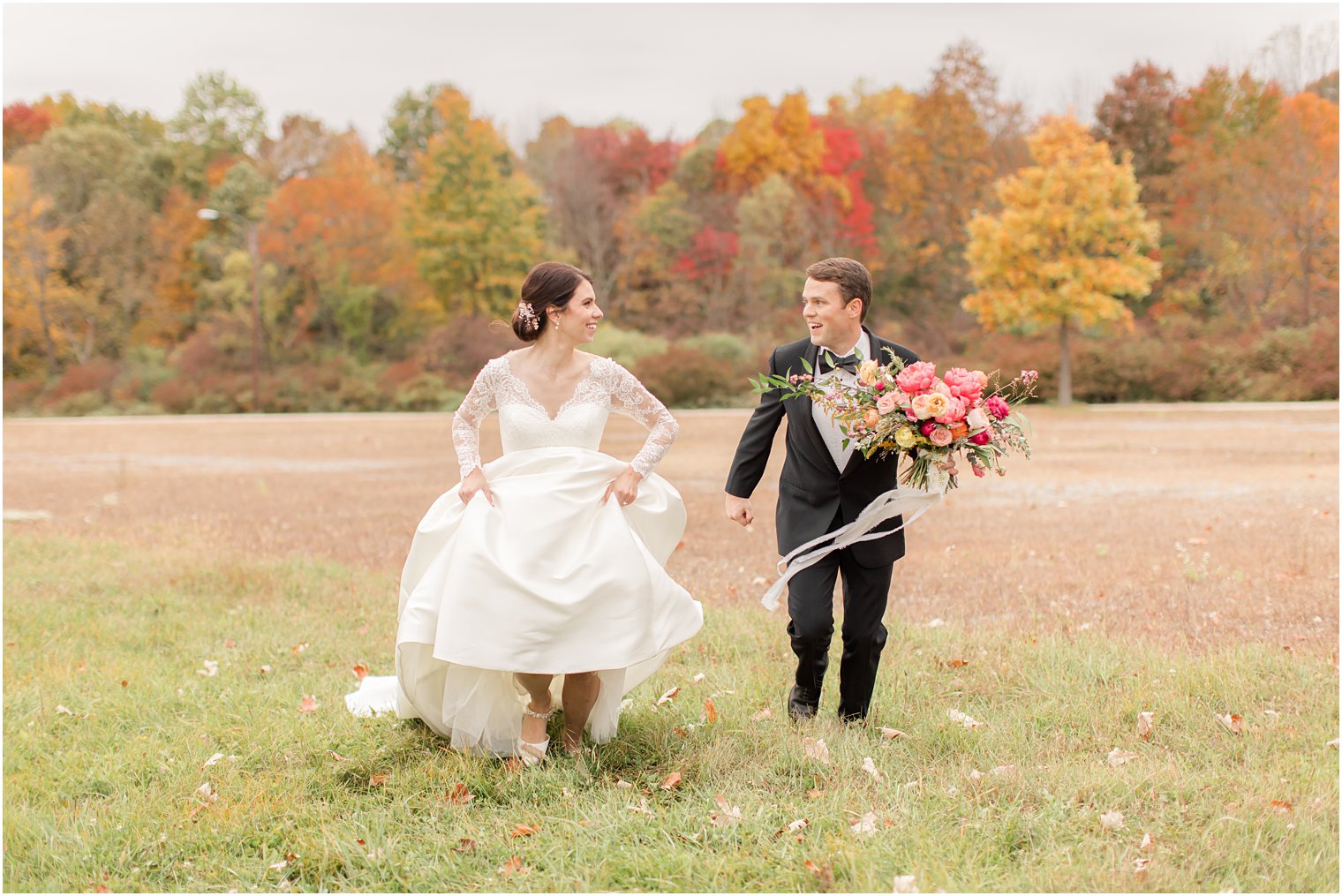 bride and groom run through field at Conservatory at the Sussex County Fairgrounds